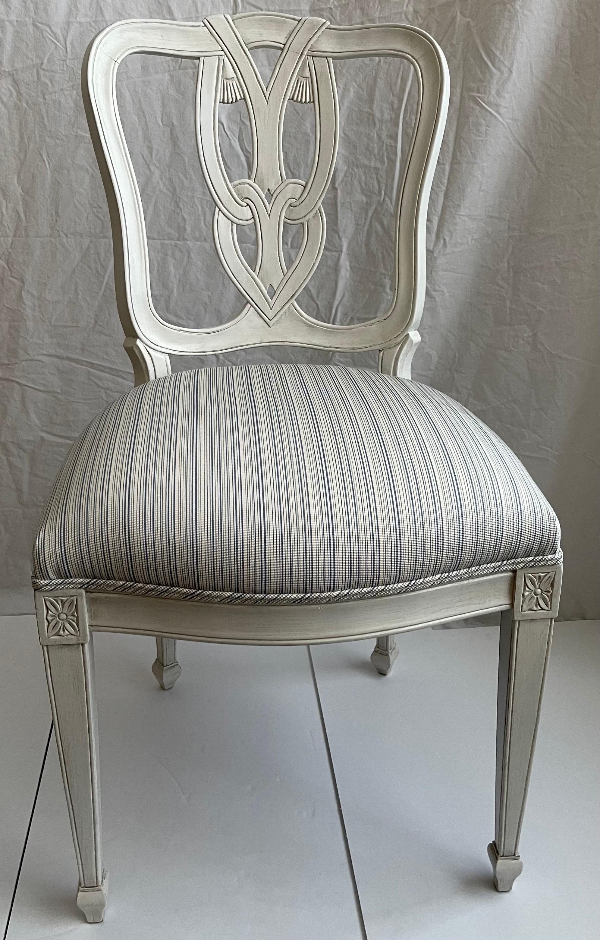 Hollywood Regency style tassel motif side chair. Newly repainted in antique white painted finish. Newly upholstered in Schumacher woven cotton fabric in blue/white stripe. Seat is 18
