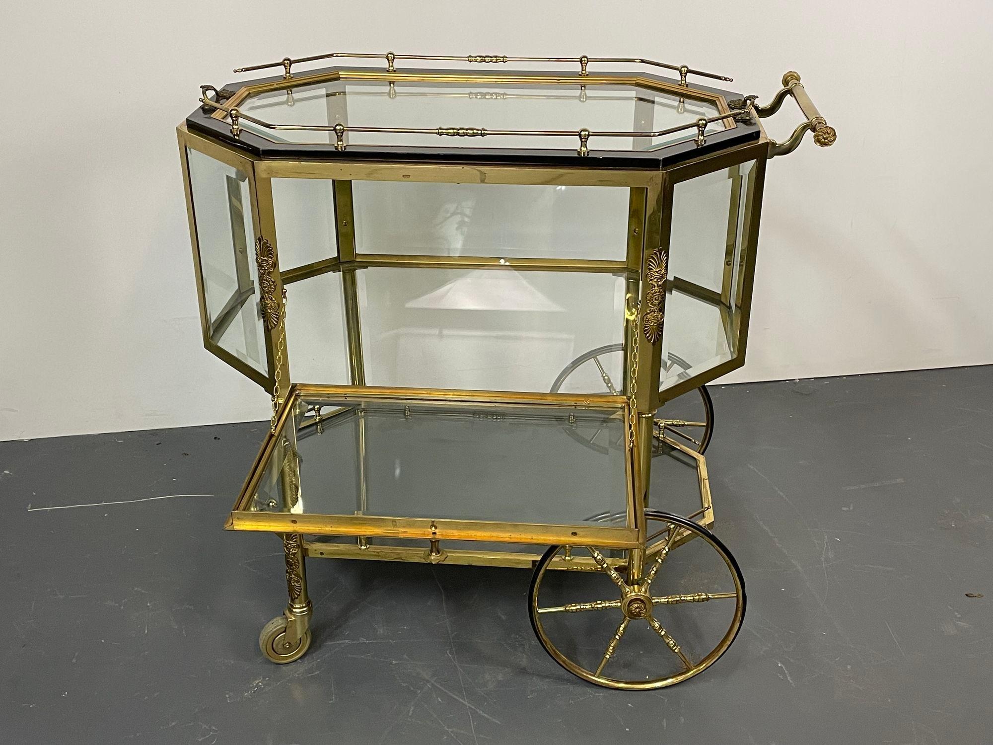 Hollywood Regency Beveled glass, bronze and brass tea Wagon or Serving Cart. One of two available.

Beveled glass bronze tea wagon or serving cart. This wonderful Hollywood Regency style cart has small wheels in front with large wheels in back