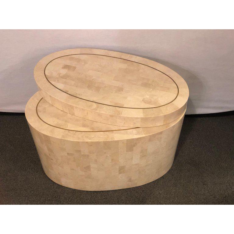 A Hollywood Regency tessellated bone swivel expanding coffee or end table in the manner of Enrique Garcel. The oval base finely decorated with a tabletop of tessellated form with boule inlay. This custom quality coffee or end table swivels to