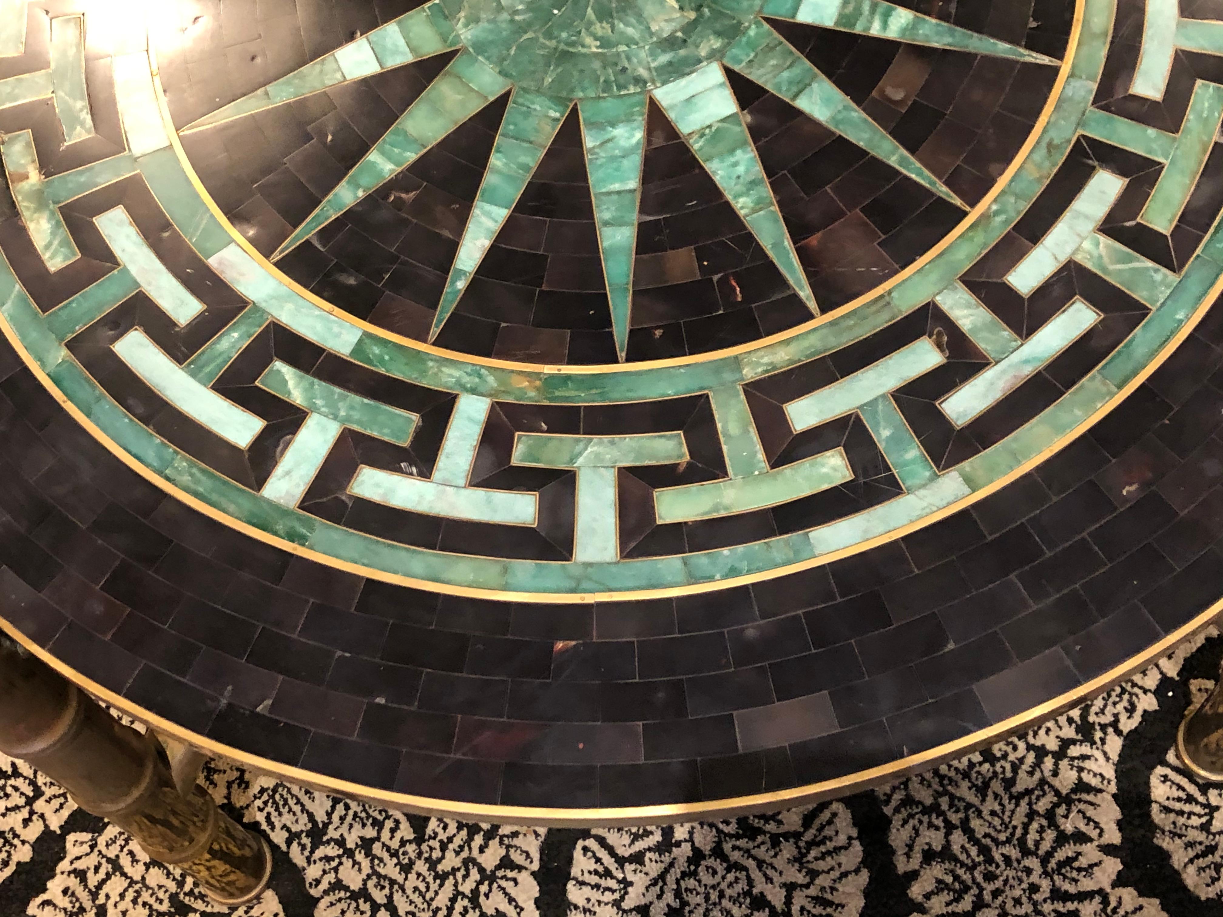 Hollywood Regency tessellated fossil stone round low table on faux bamboo brass legs in the manner of Karl Springer having Star and Greek Key decoration. Possibly made by Maitland-Smith.