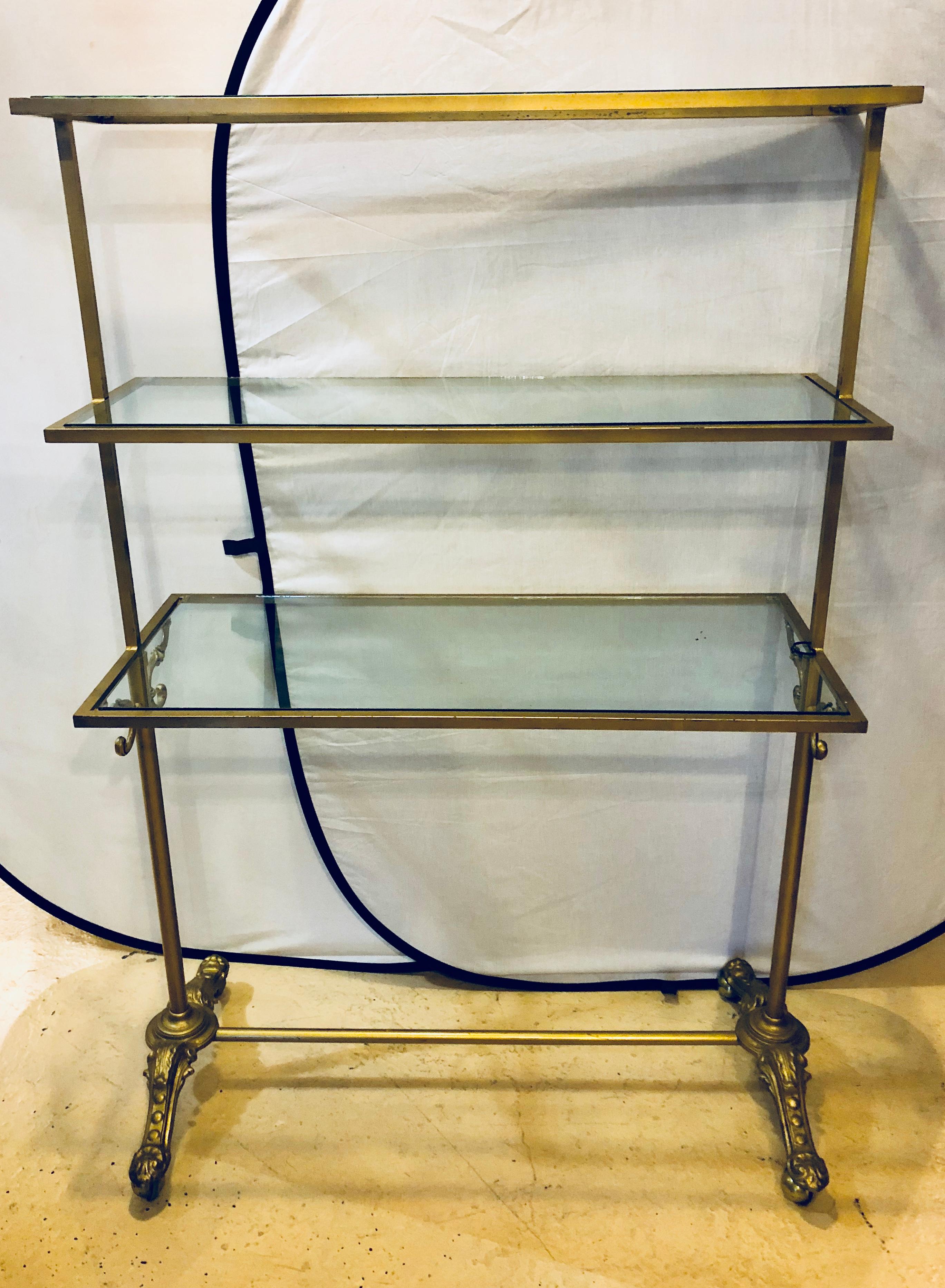 A Hollywood Regency three-tier large bakers rack gilt metal and glass shelves. A large and impressive bakers rack that is certain to add years of style and grace as well as serving a purpose to any kitchen or dining serving room in the home. 

ZXX.