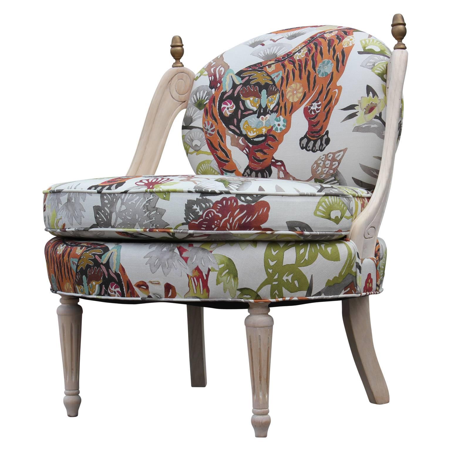 Exquisite Tiger Hollywood Regency slipper lounge chairs. This chair has been reupholstered in a Kravet Sumbar patterned fabric. The frame of the chair has been stripped and bleached. The chair has been fully restored and is in excellent condition.