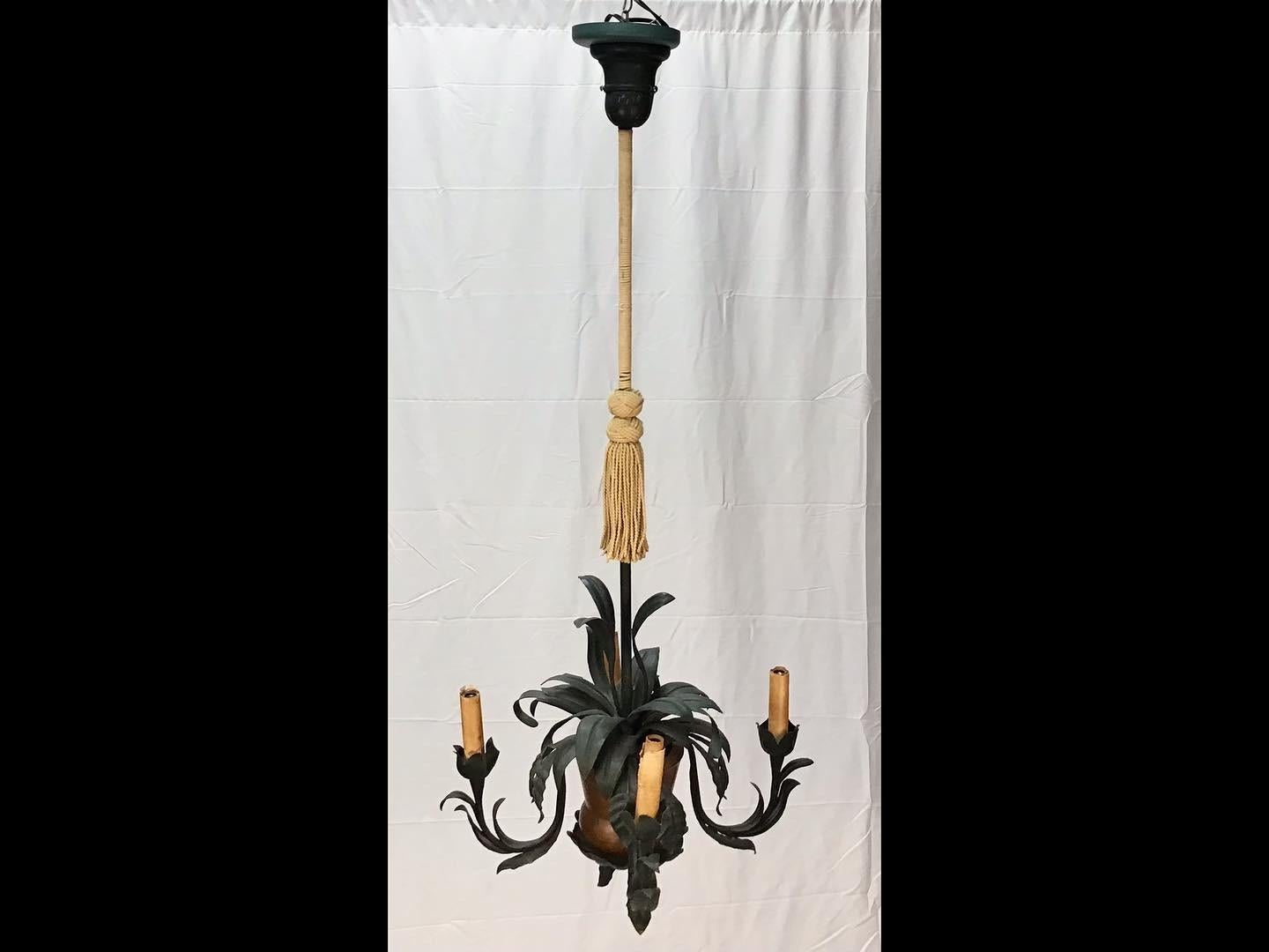 Eye-catching hand-hammered copper basket with tole palm frond leaves palm tree ceiling light fixture. A copper basket supported by a long metal pole wrapped with a tassel. The basket with tole palm fronds and four arms with lights. A truly unique