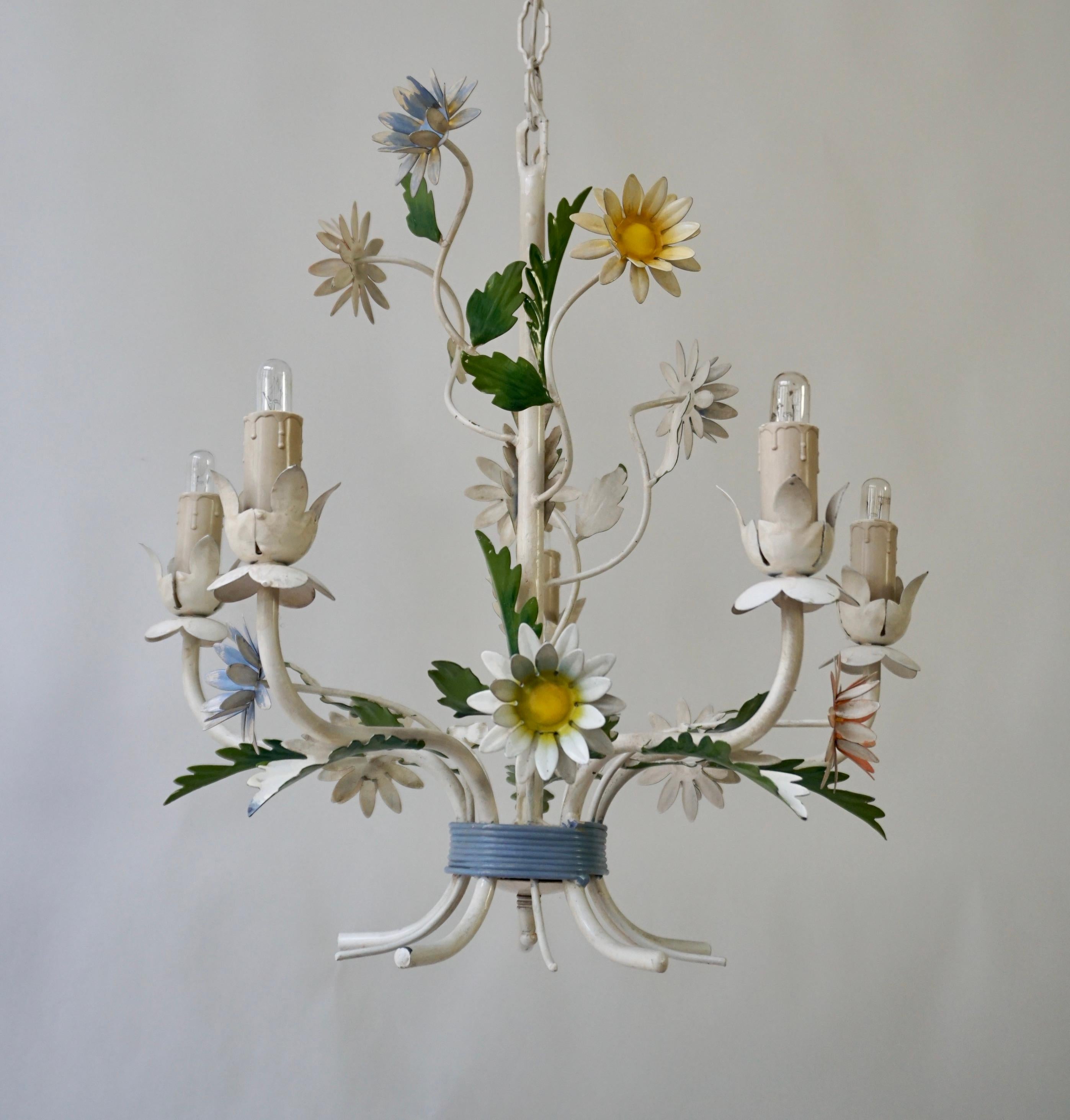 A vintage tole five-light chandelier with flower and leaf accents. Original paint finish in vibrant greens, white, and different shades of brown.  

Diameter 17.3