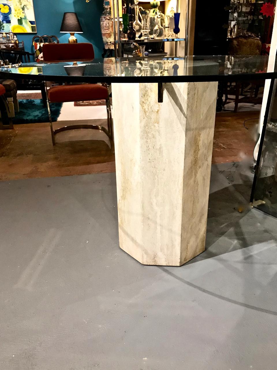 This is a high style 1980s travertine marble, glass and brass small dining table in the style of Fontana Arte. This super chic table would integrate well into either mid-century design or into a traditional aesthetic. The table is in overall very