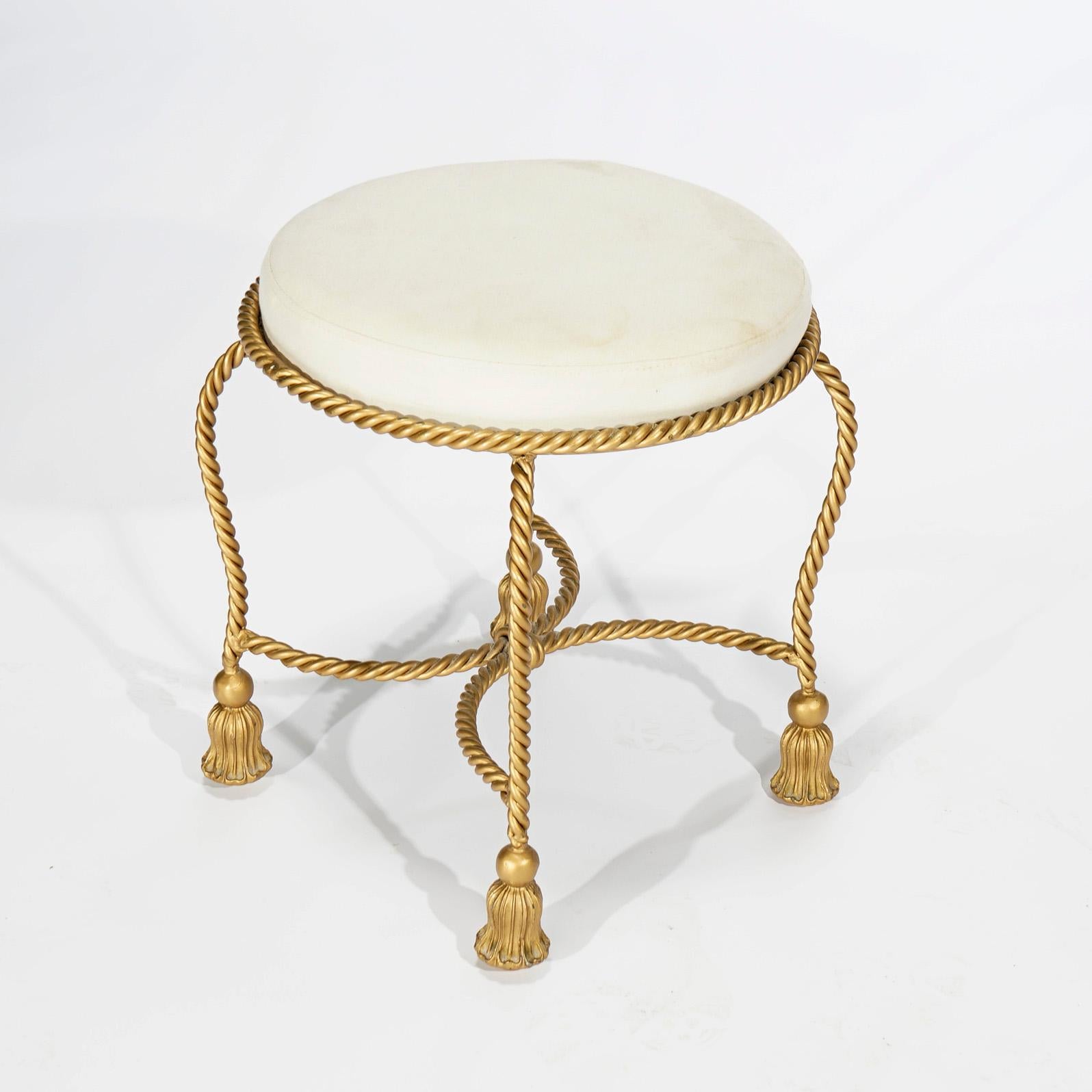 A Hollywood Regency vanity stool offers upholstered seat over rope twist gilt metal frame having tassel form feet, 20th century

Measures- 21'' H x 19.25'' W x 19.25'' D.
    