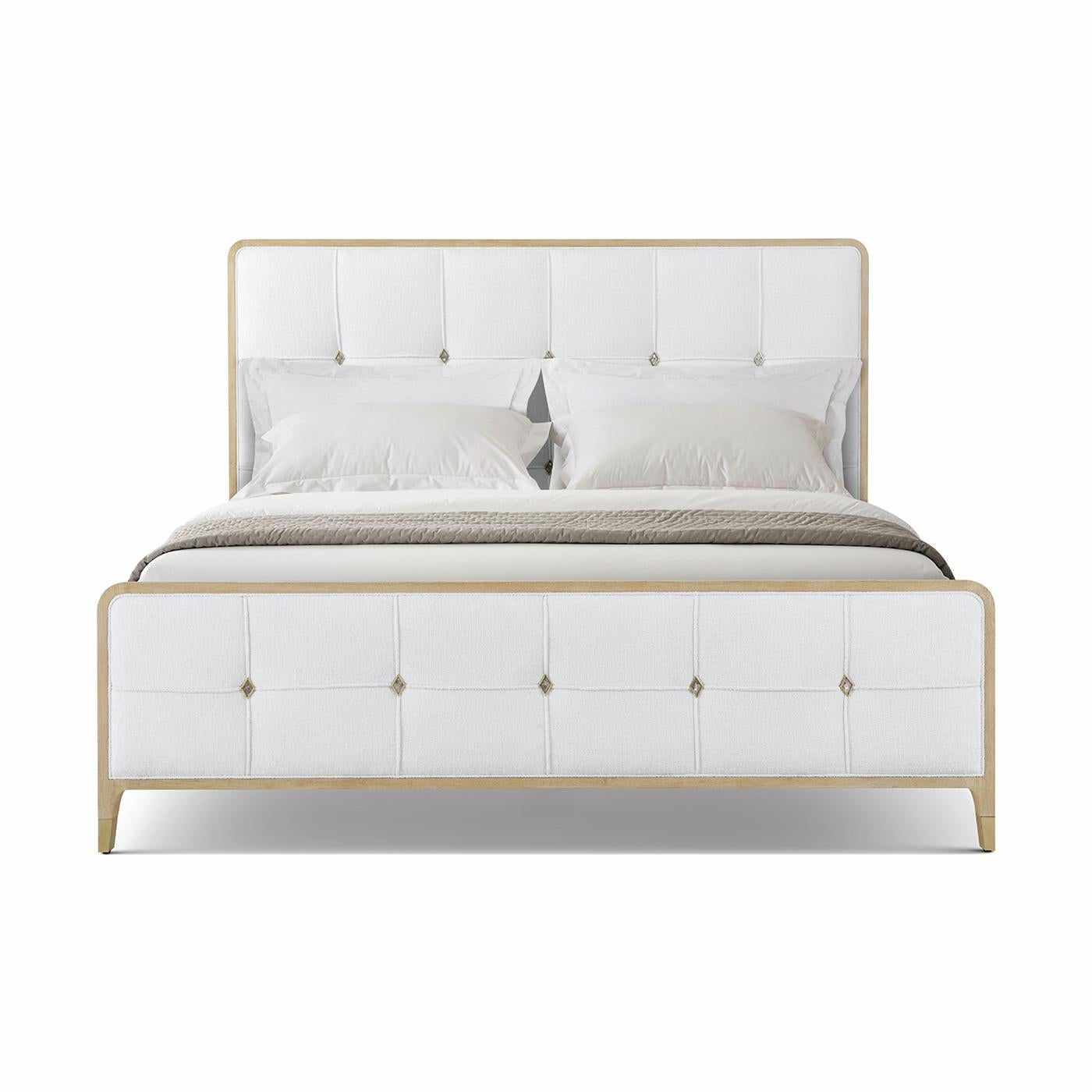 A luxurious statement piece for those who embrace an elegant approach to life. Shown in a light wood Martini finish frame, this bed features tailored diamond-tufted upholstery framed in a sleek wood silhouette. Each tuft is accented with refined