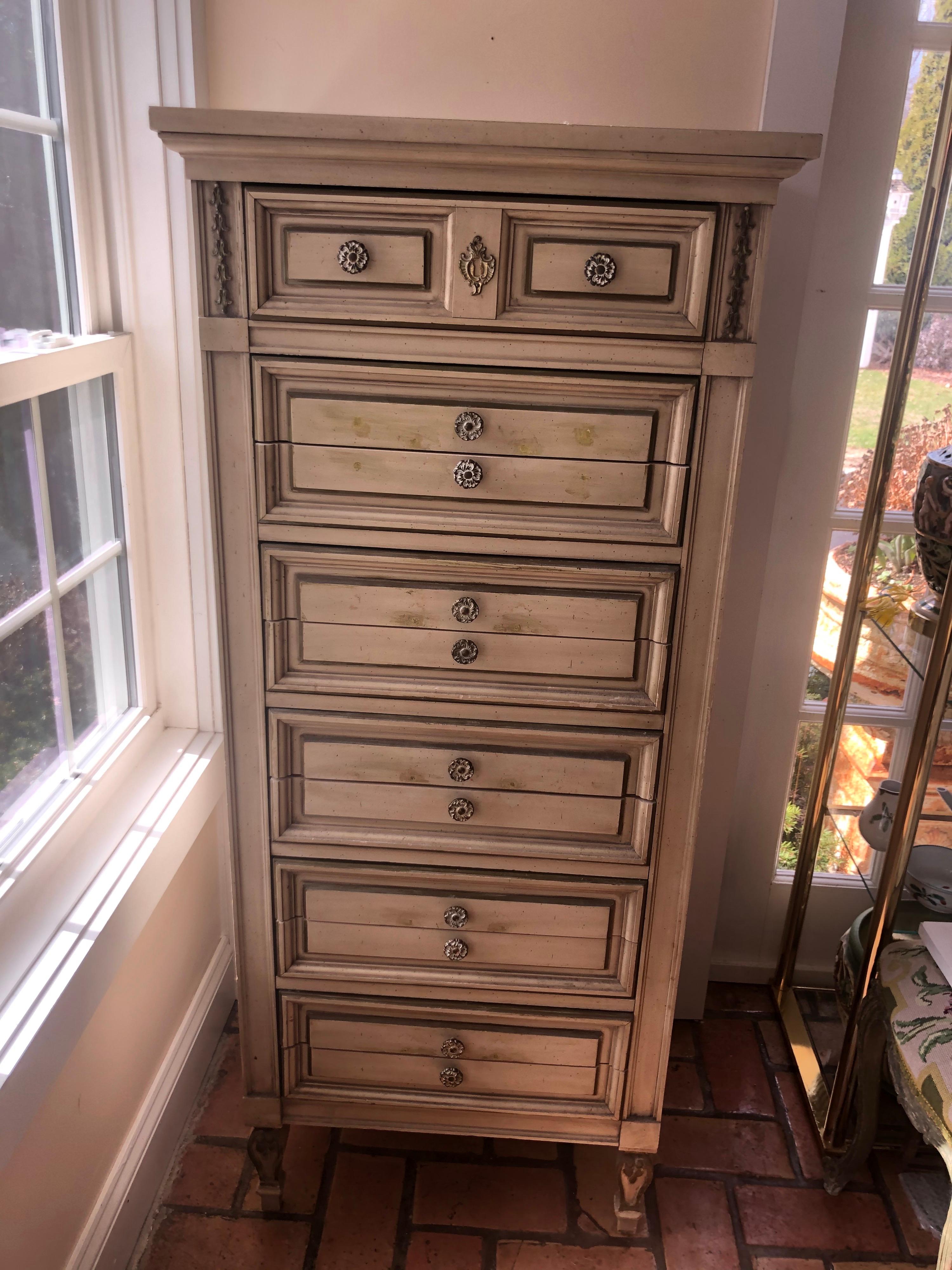 Hollywood Regency upright jewelry dresser. This vintage piece made by Dixie has been custom fitted for jewelry. The original knobs have been moved to make better use of this dresser/semanier for holding jewelry. Thin sliced 11 drawers allow for