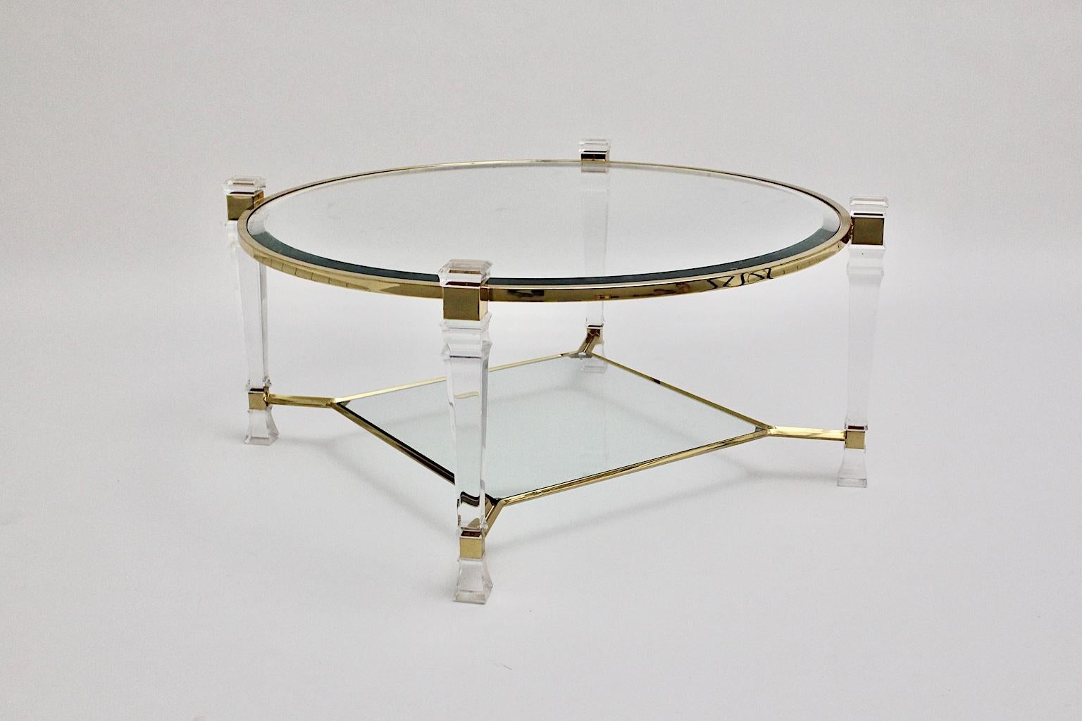 Hollywood Regency style vintage coffee table or sofa table from lucite and glass Pierre Vandel style circa 1970, France.
An elegant two-tiered coffee table with a lucite table frame and golden details and also two clear glass plates.
The top plate