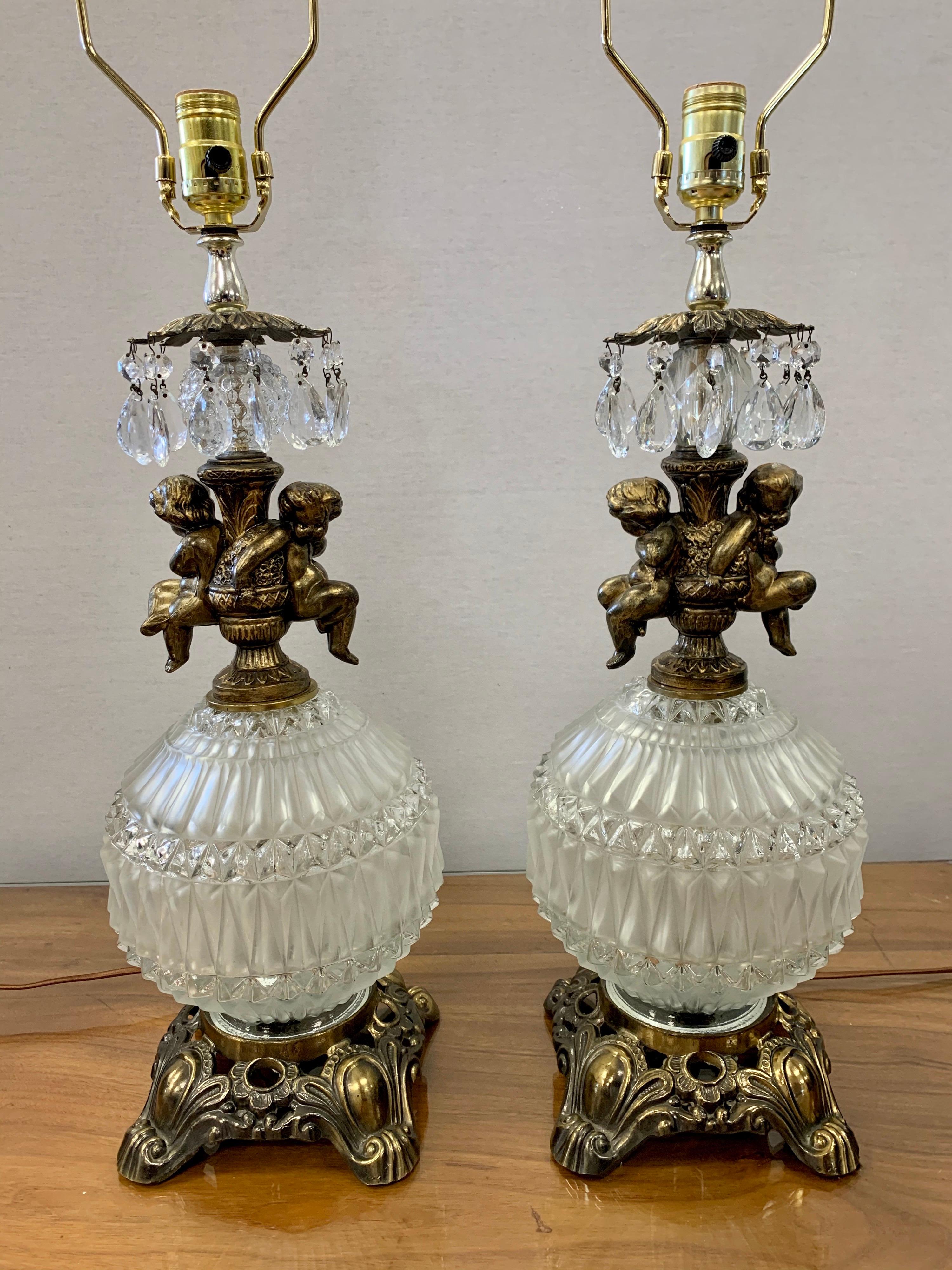 Elegant pair of frosted glass and brass table lamps with iconic Hollywood Regency
style. These table lamps stand tall at almost three feet from top to bottom and have
gorgeous lines. Wired for US and in perfect working order. Mint condition. Now,