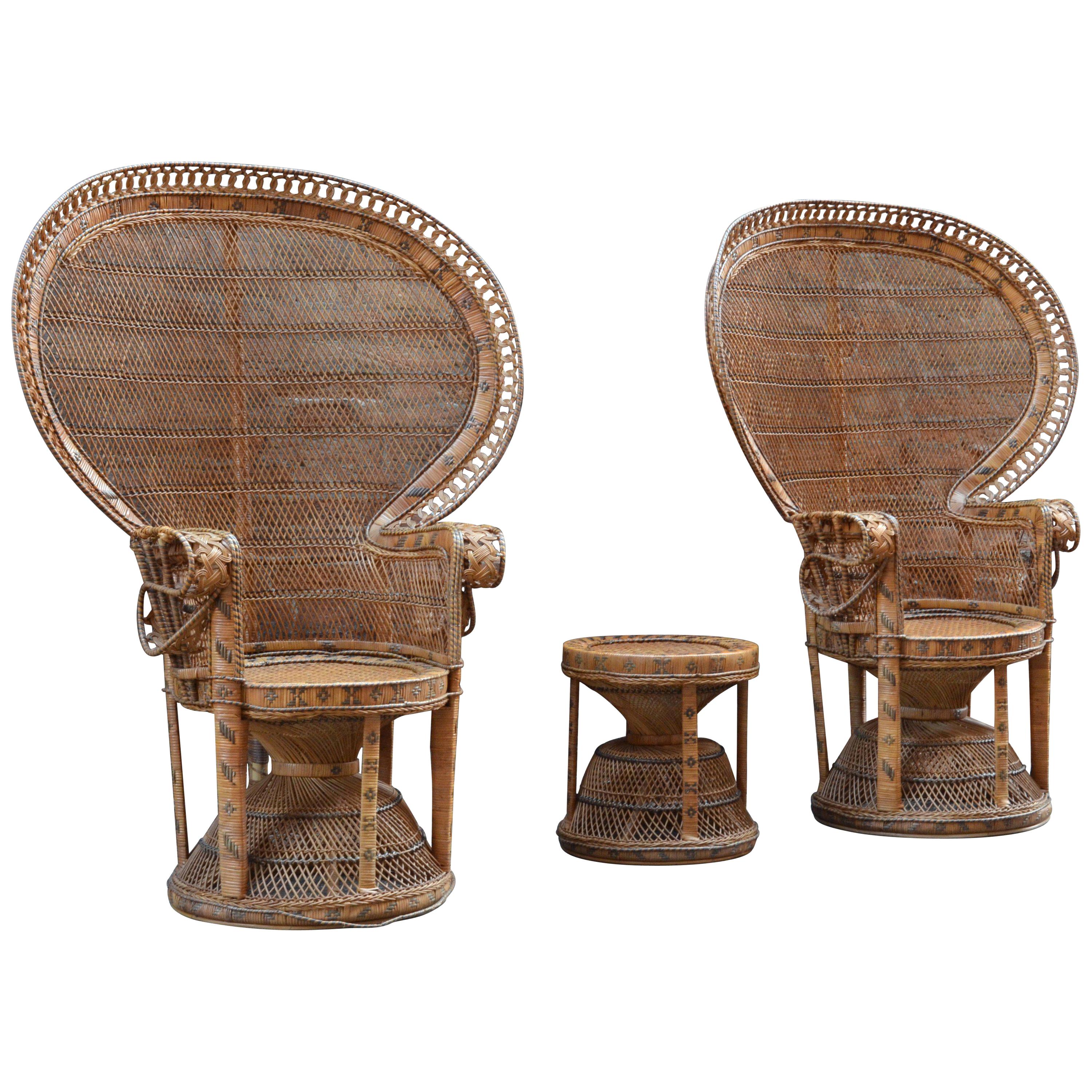 Pair of rattan and wicker peacock armchairs with matched stool. They are form 1970s and come from Italy. Featuring a full fan back, these handwoven chairs were designed at the height of the Hollywood Regency. With their shape and big dimensions they