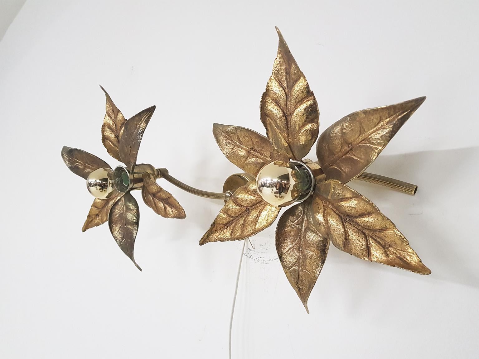 Fantastic wall or ceiling light in the shape of a flower. The lamp features two flowers on pole connected to a wall or ceiling plate. In the middle of the golden flowers, there is a bulb with a golden reflector. These bulbs come with the