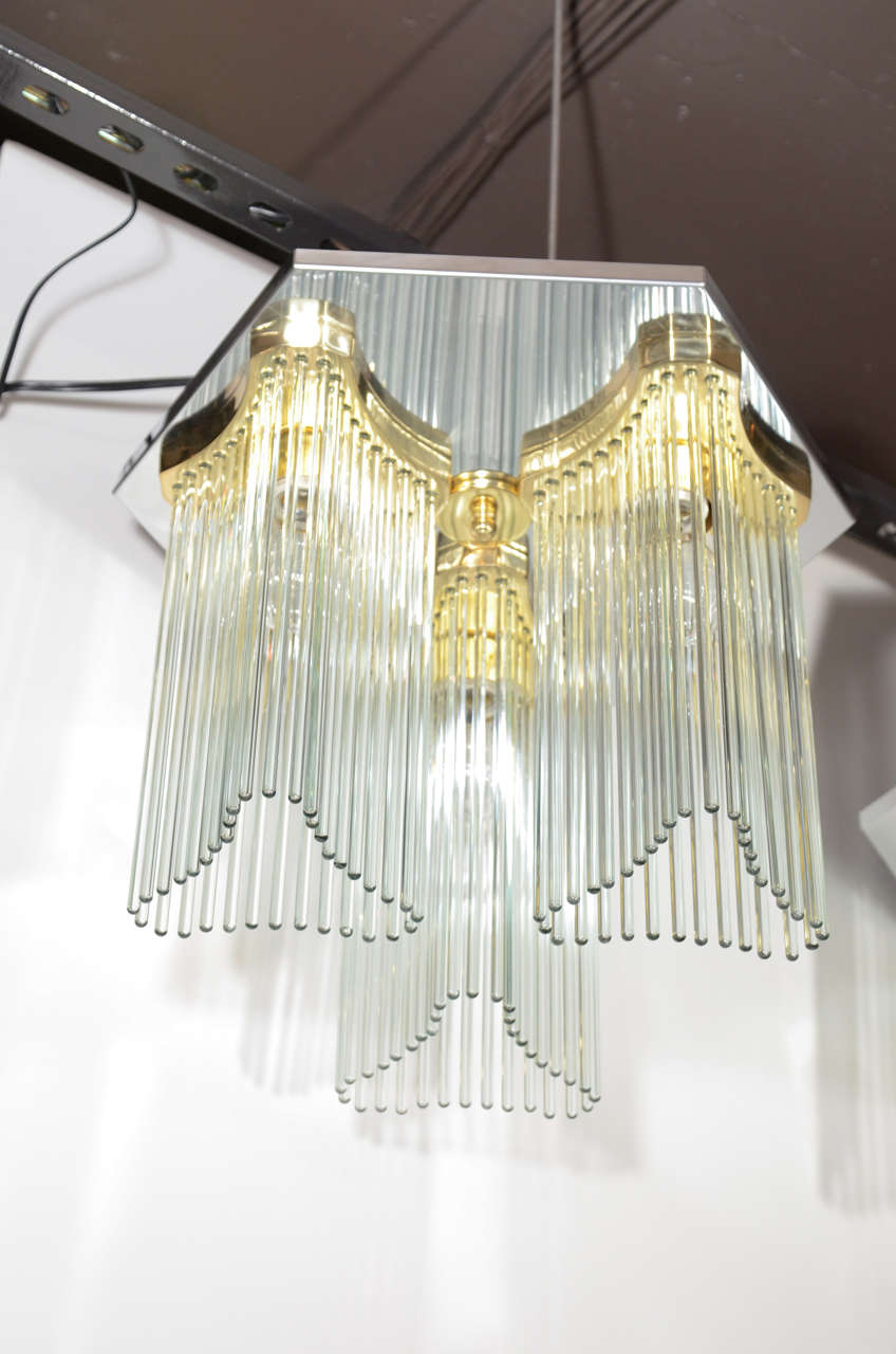 Mid-Century Modern flush mount chandelier designed by Gaetano Sciolari for Lightolier. Chandelier has hexagon frame in chrome with stylized three-sided brass centre fittings that feature long hanging glass rods. Hollywood Regency design that mixes