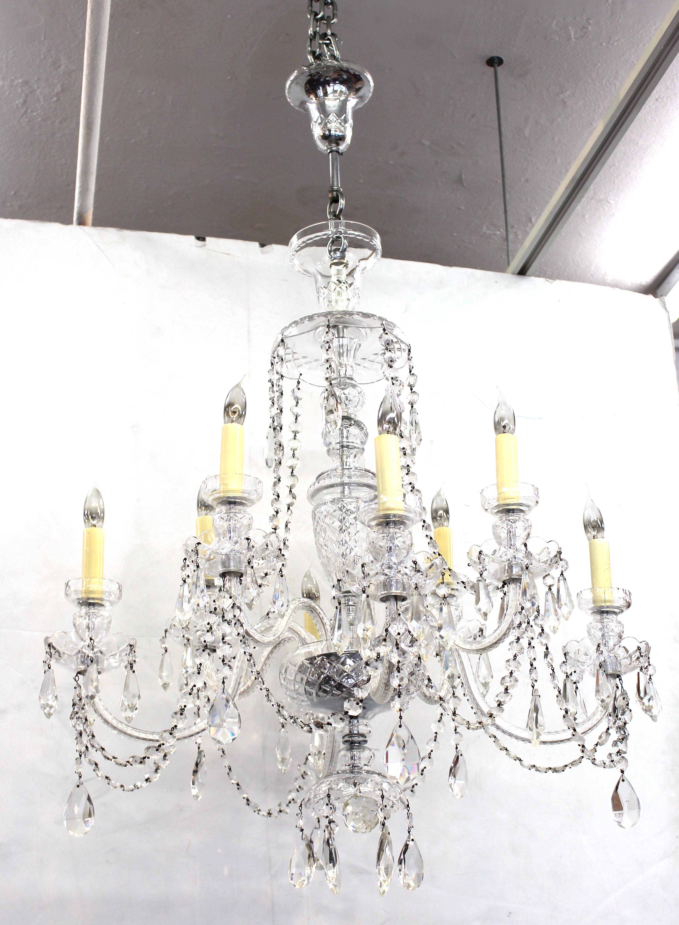 Hollywood Regency midcentury crystal chandelier in Waterford style. The piece has age-appropriate wear and is in overall great vintage condition.