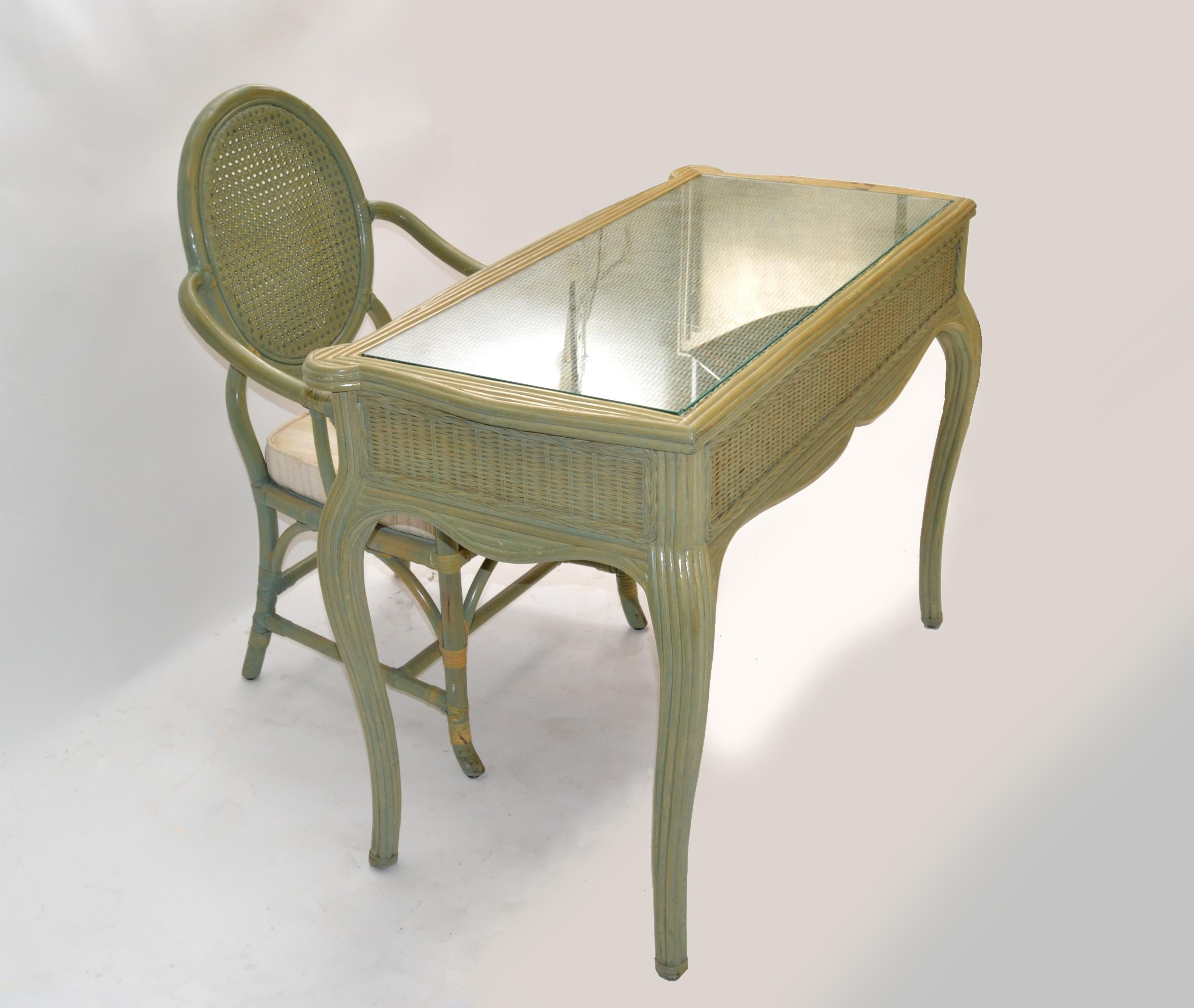 Hollywood Regency bamboo & reed desk, writing table or vanity with glass top and matching armchair in olive green finish.
Features 2 drawers with hand carved seashell pull.
The glass top is perfect for a smoother surface, ideal for your daily office