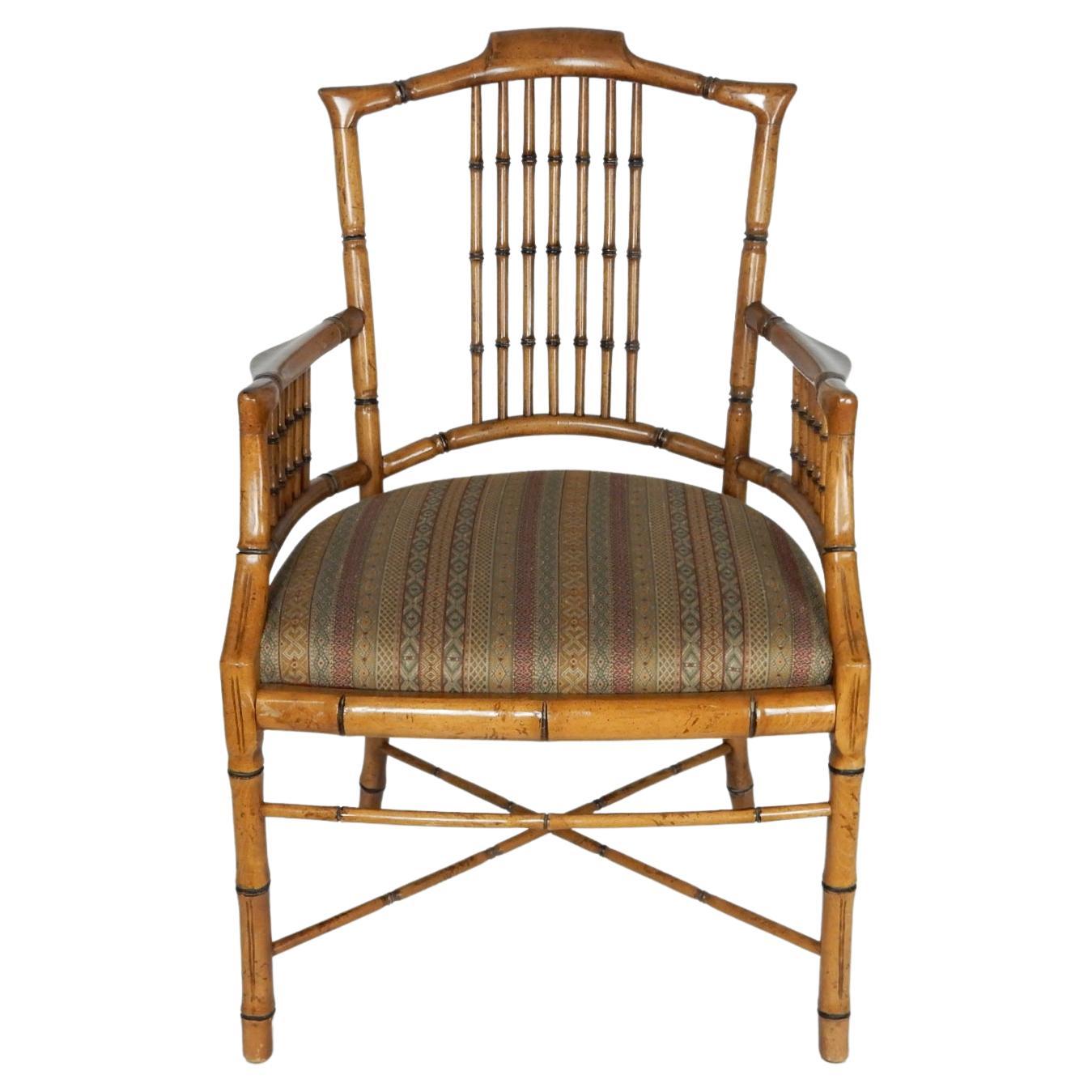 A pair of arm chairs attributed to Baker Furniture CO., circa 1960s. 
This is a seldom seen version with the tall back and wide arm rests.
Reupholstered at one time with striped pattern fabric.
These have been cared for over the years showing no