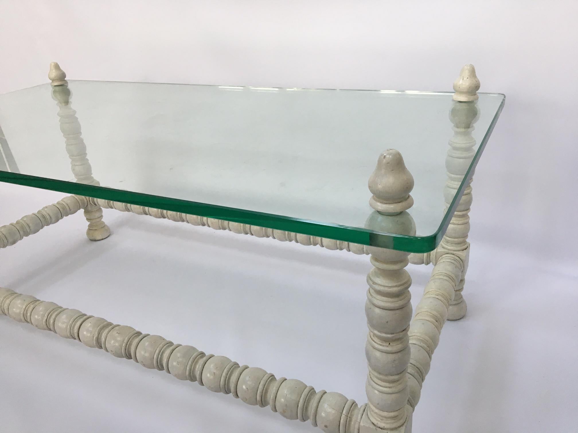 White carved wood bobbin leg Jacobean style coffee table with 3/4 inch thick glass top. Good vintage condition with imperfections to the wood finish. Glass in excellent condition.