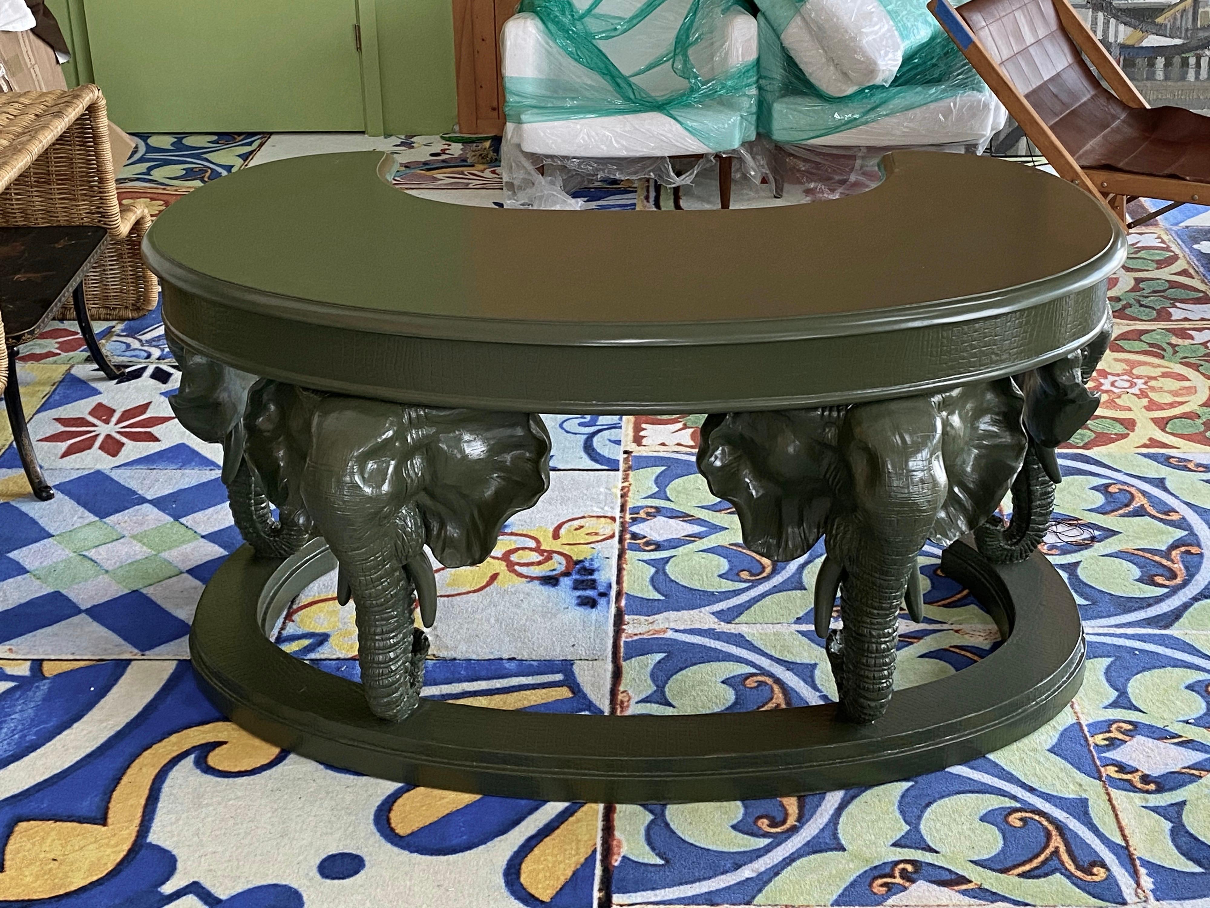 Very unique Hollywood Regency desk with elephant shaped columns. Has drawer with brass handle. Just refinished surface.