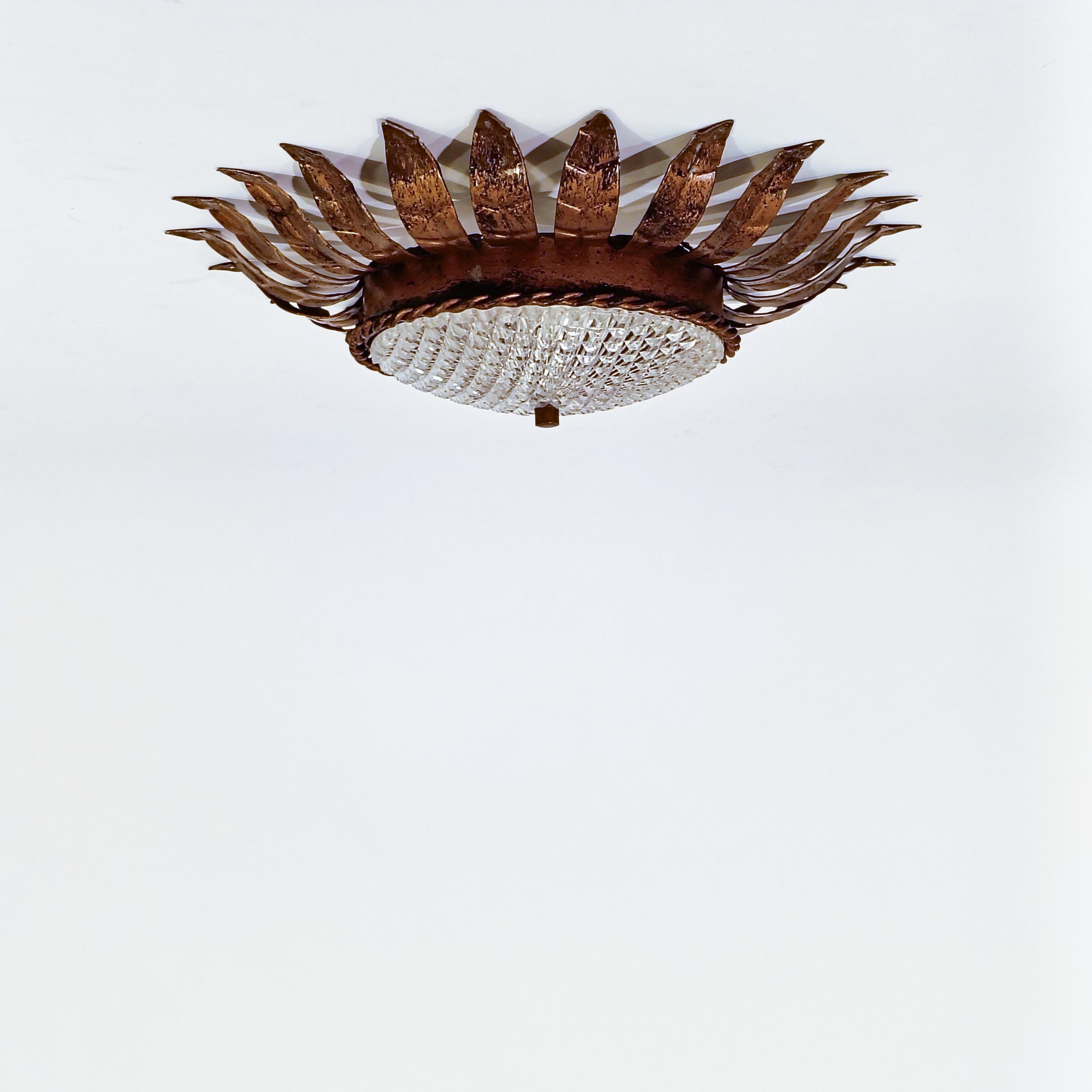 Spanish Hollywood Regency. Wrought iron Sunburst flush mount by Ferro Art, Spain, 1950s For Sale