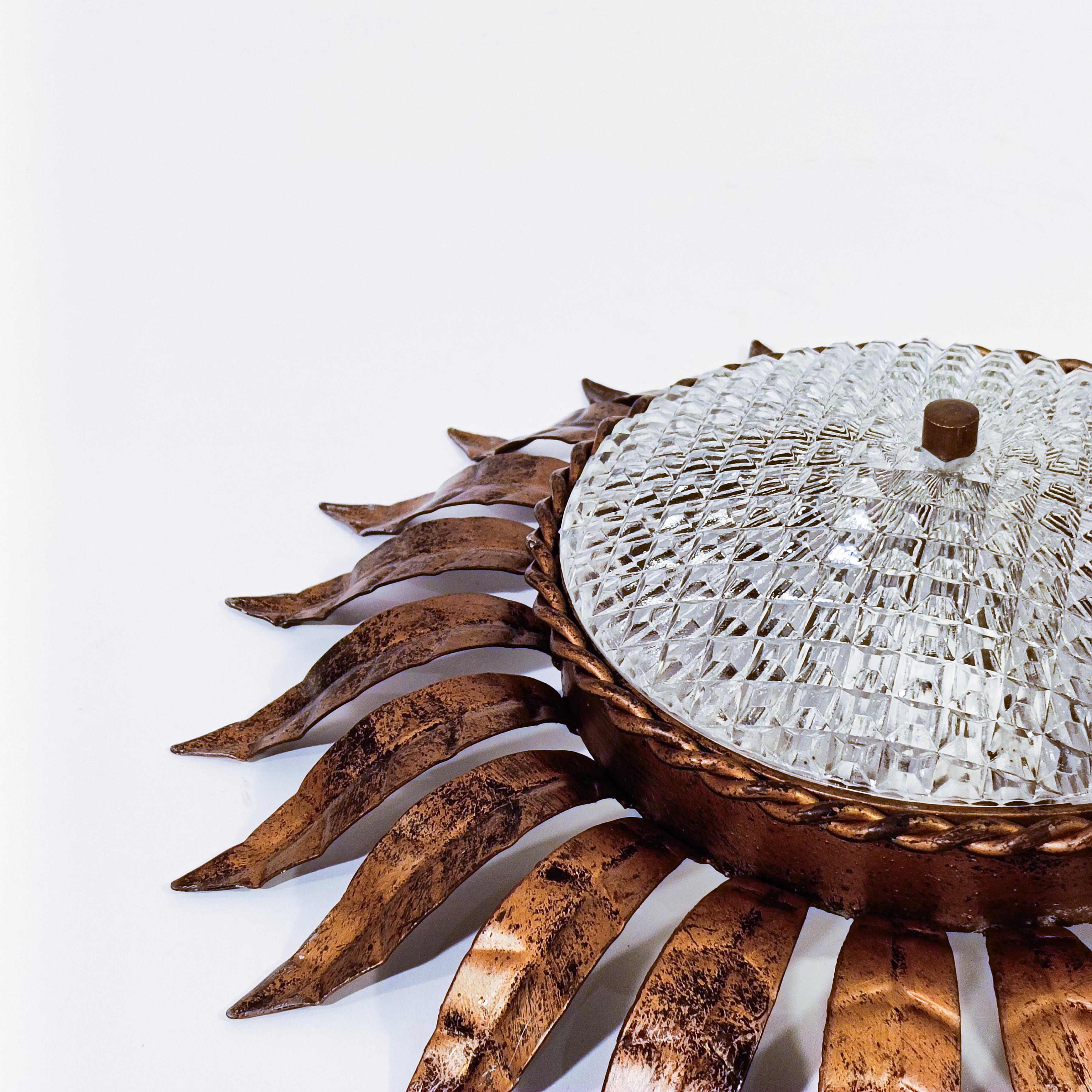 Hand-Crafted Hollywood Regency. Wrought iron Sunburst flush mount by Ferro Art, Spain, 1950s For Sale