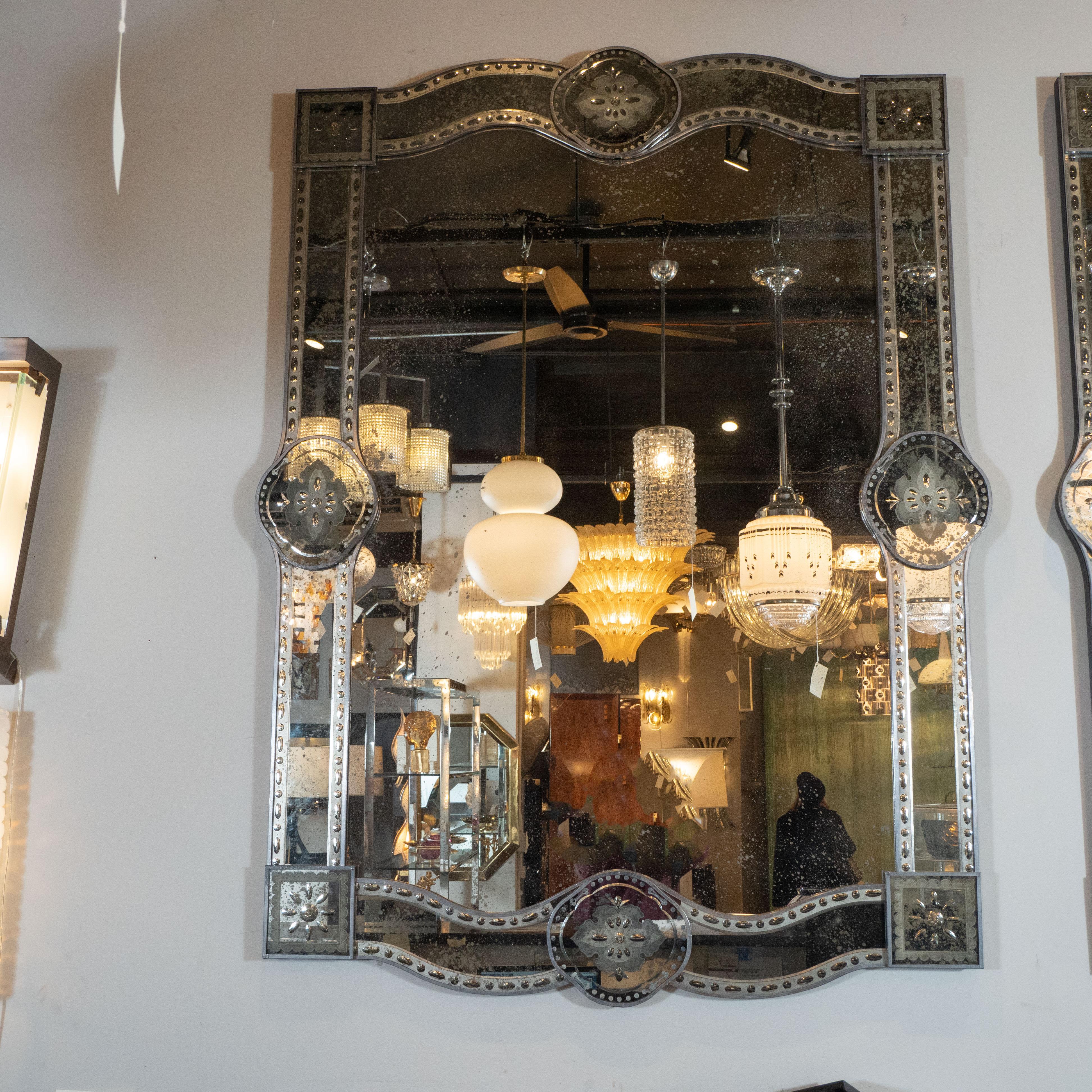 This stunning Hollywood mirror was realized in Italy, circa 1950. It offers silvered rectangular forms with an undulating top. The sides are overlaid on the base with additional panels in the center of each side as well as the corners, creating a