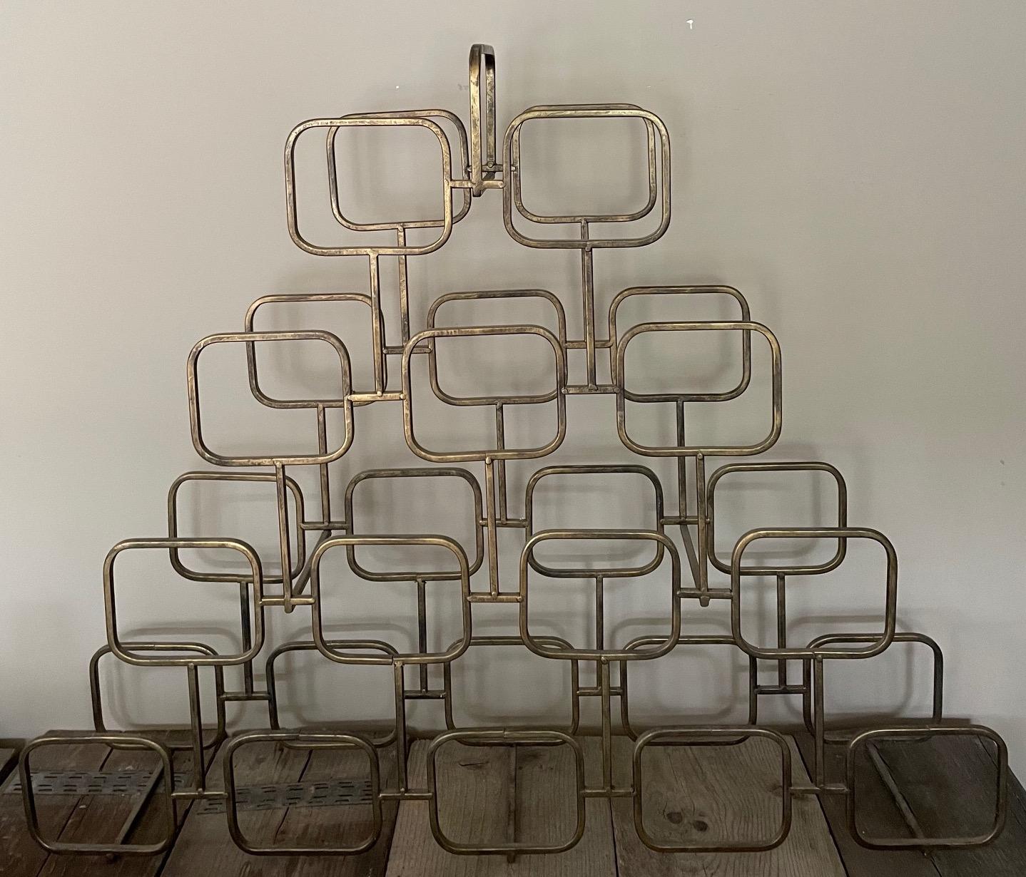 Hollywood style Regenccy bottle holder, quite slim in gold-coloured iron, but large enough to hold 14 bottles.