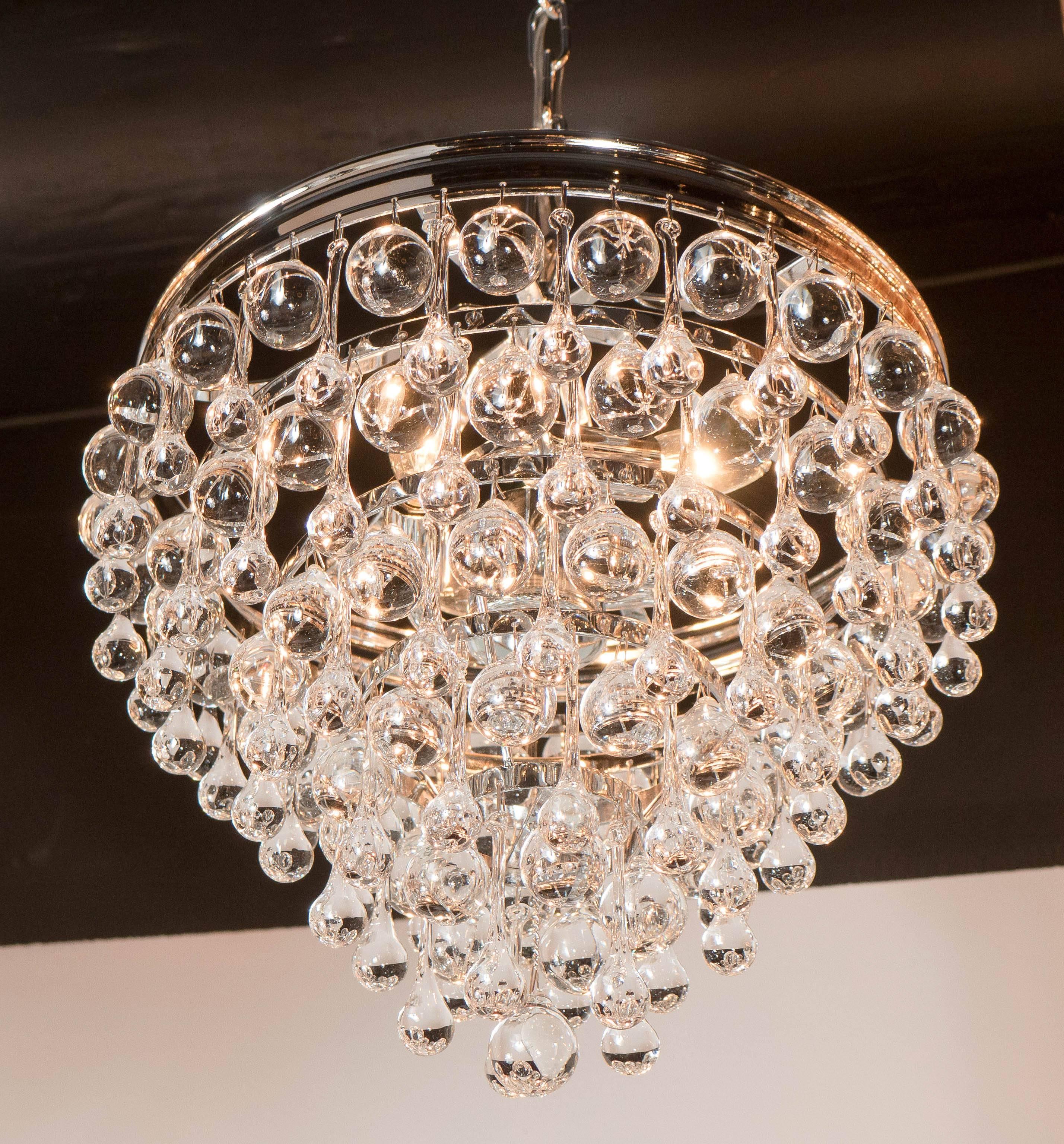 An elegant flush mount chandelier with contrasting crystal ball and teardrop glass segments in a radial pattern. The result is a very sparkling effect typical of Hollywood style and glamour. The fixture is nickel and the glass is handblown.