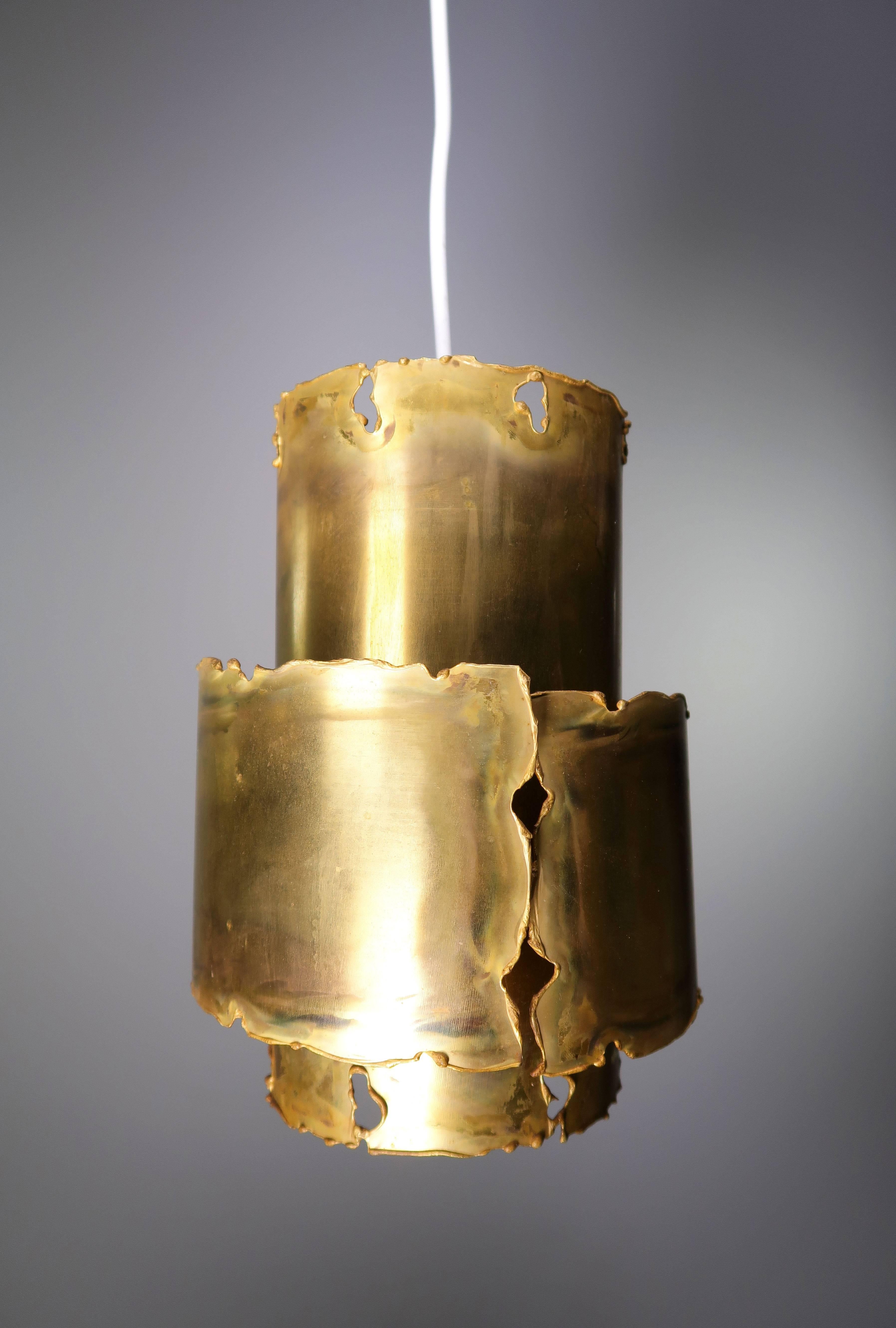 Classic and unique Holm Sorensen handmade Danish Brutalist Mid-Century Modern brass pendant showing the designer's signature metal treatment method: Flame cut edges and acid treated surfaces to bring out the nuances in the metal and make it come to