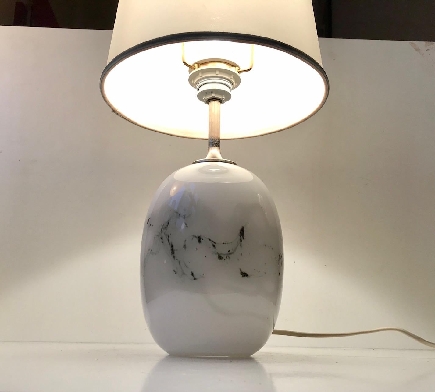 Ovoid shaped art glass table lamp designed by Michael Bang and manufactured by Holmegaard in Denmark during the late 1970. It is called Sakura. Label from Holmegaard still present beneath the base. The shade holder is included. The shade is not