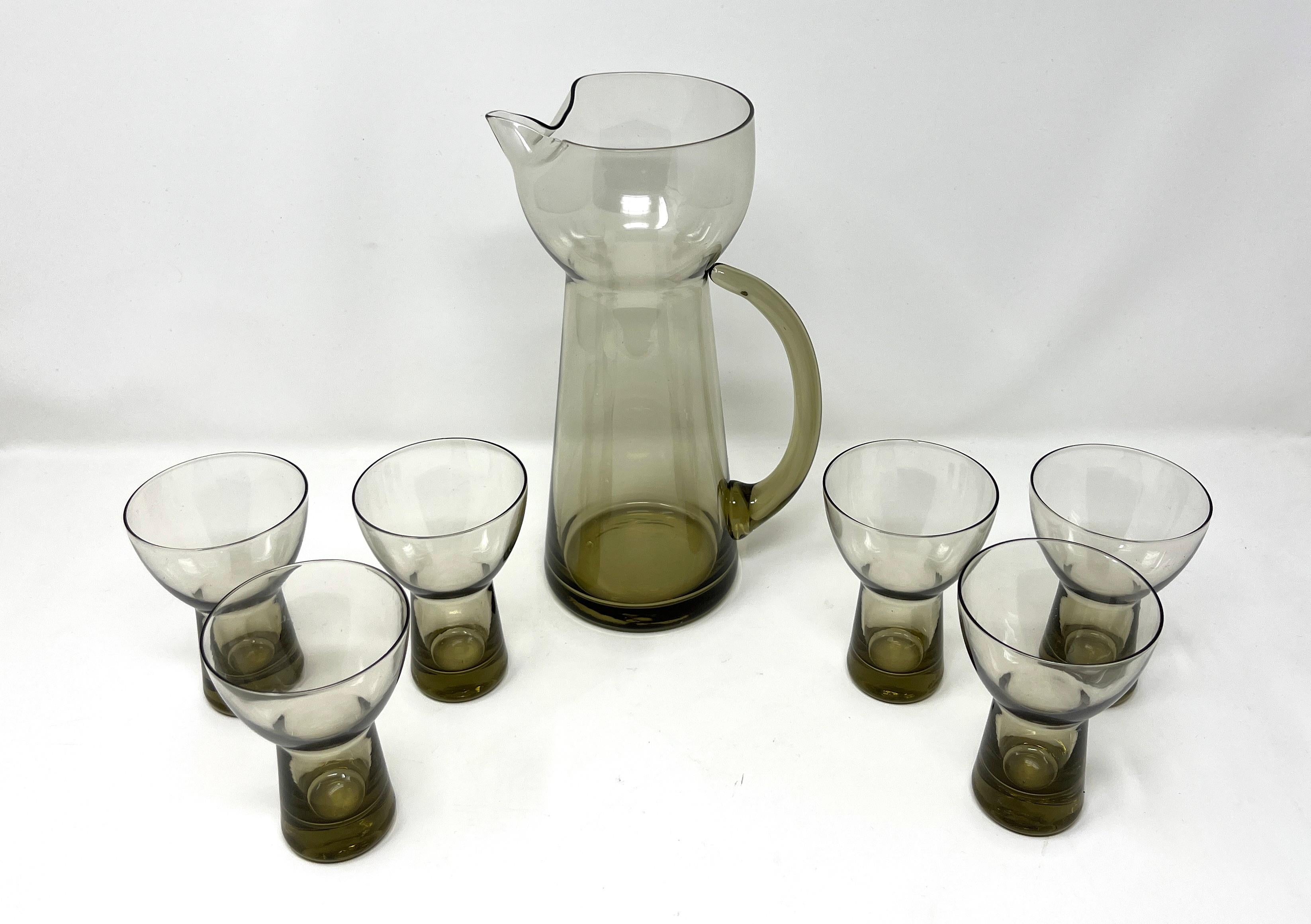 Handled Danish Modern glass handled cocktail pitcher and set of six (6) matching stunning smoke gray-brown aperitif glasses. There are no markings, but they are   handblown, and possibly by Holmegaard. Really gorgeous, sleek and artistic.