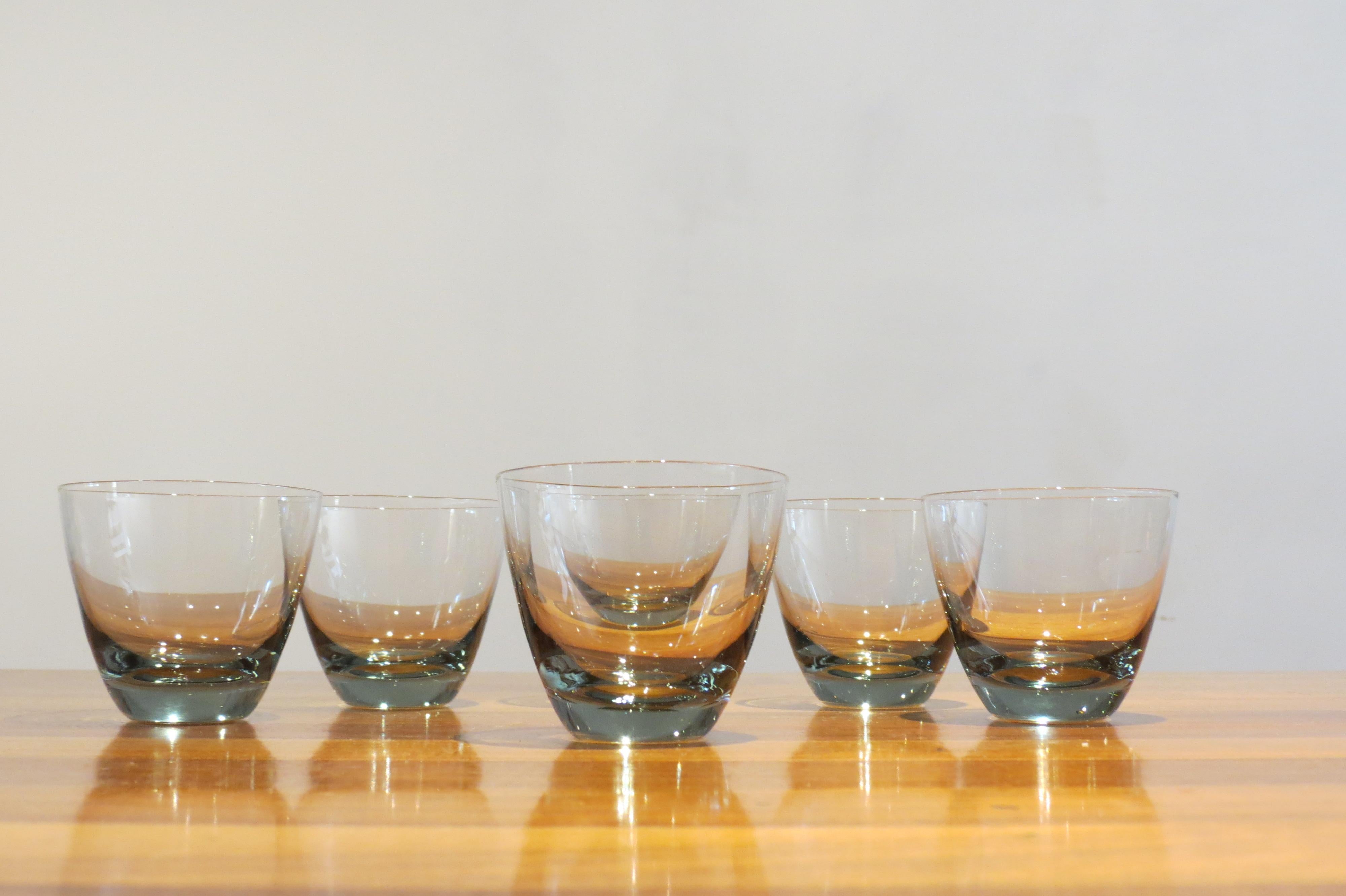 A set of six vintage Holmegaard glasses.
Designed by Per Lutken, model Copenhagen, 1950s.
Measures: 6cm tall, 7cm diameter widest point.
Smoked glass.
Good condition, two glasses have a blemish on the side of the glass, this probably appeared