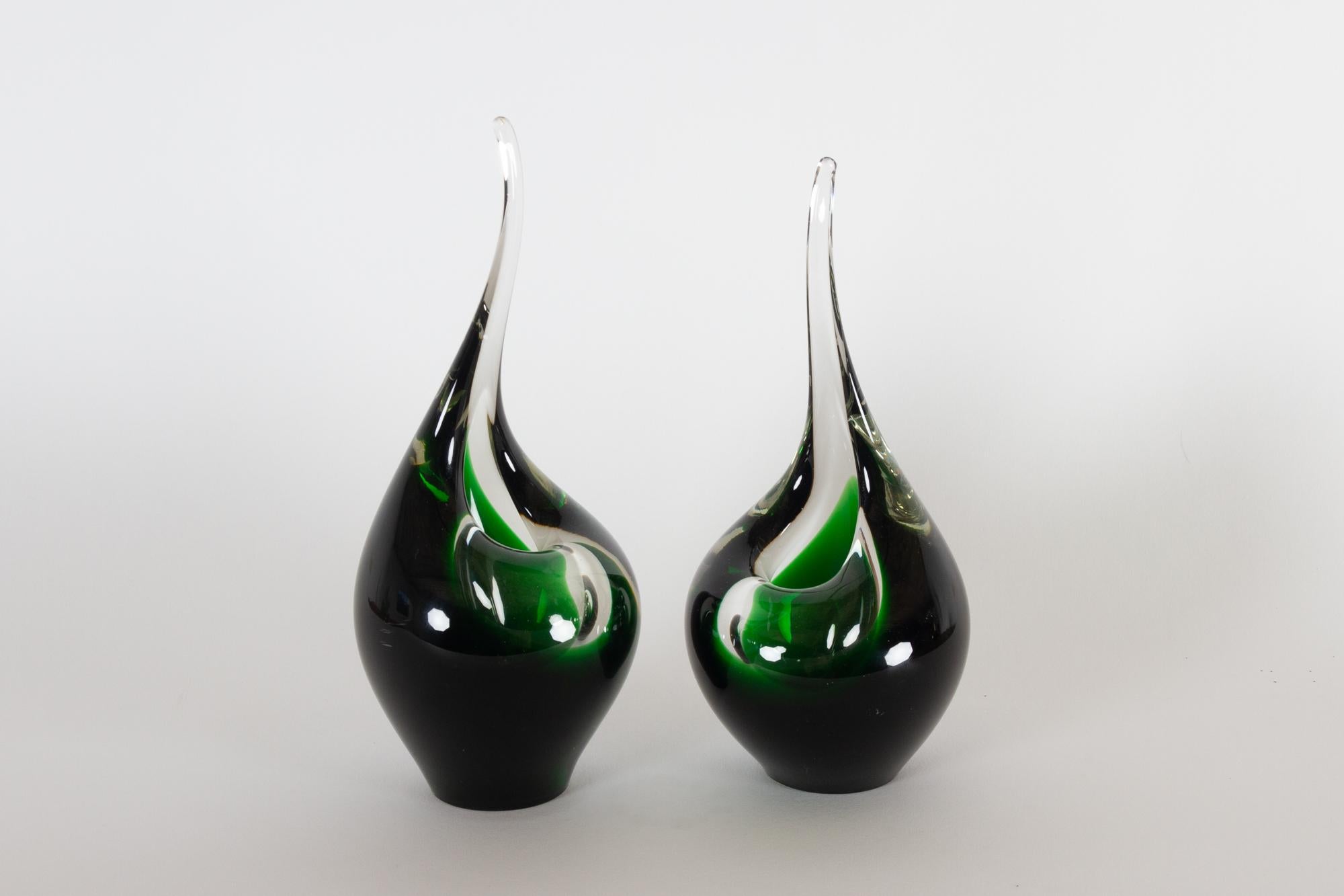 Holmegaard Flamingo vases by Per Lüthen, 1961.
Flamingo is a series of tear shaped orchid vases with an upright point in green and transparent glass. Mouth blown and drawn. Not that many are left, as the tip is very fragile.
Designed in 1953, made