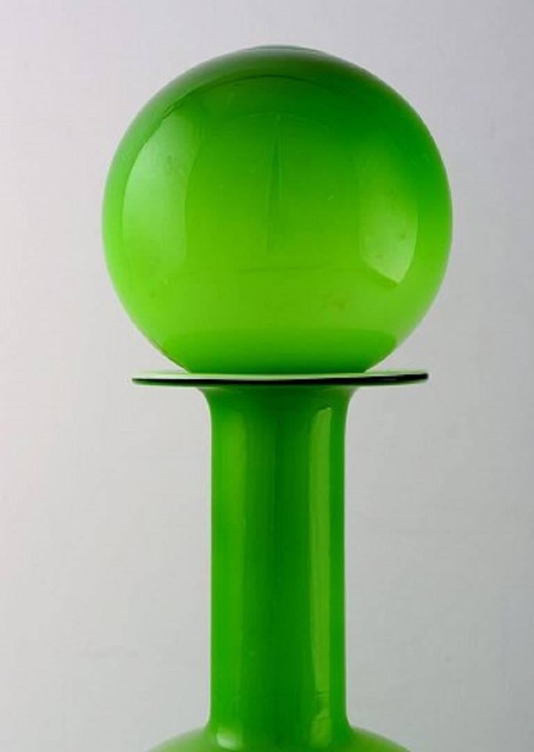 Holmegaard large bottle, Otto Brauer. Spherical stopper.
Bottle in light green.
Measures: 38 cm. x 12 cm.
In perfect condition.