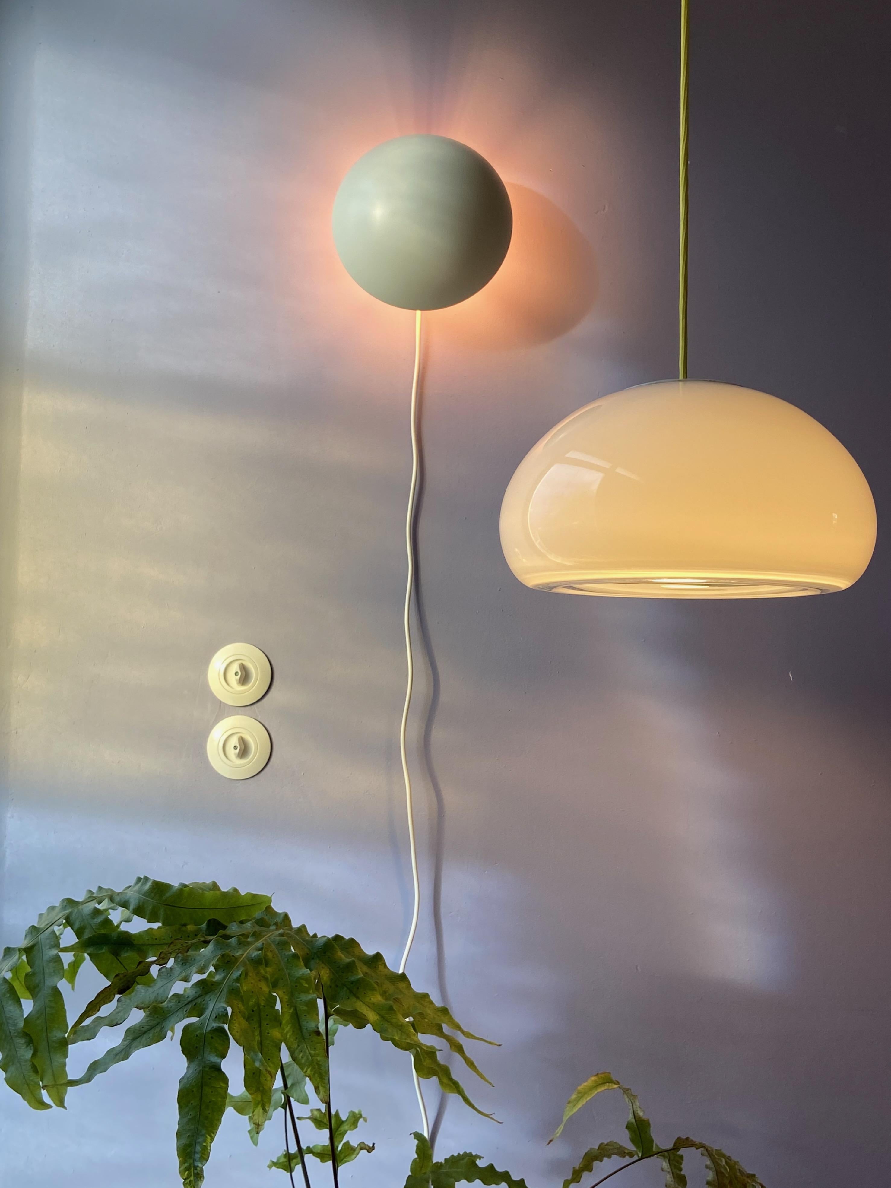 A rare large (Sunset Stor) hand-blown cased white opaline glass pendant light designed by Per Lütken 1983 and manufactured by Holmegaard in Denmark. The lamp comes with a E27 screw socket and new fabric cord and ceiling cap, ready to use worldwide.