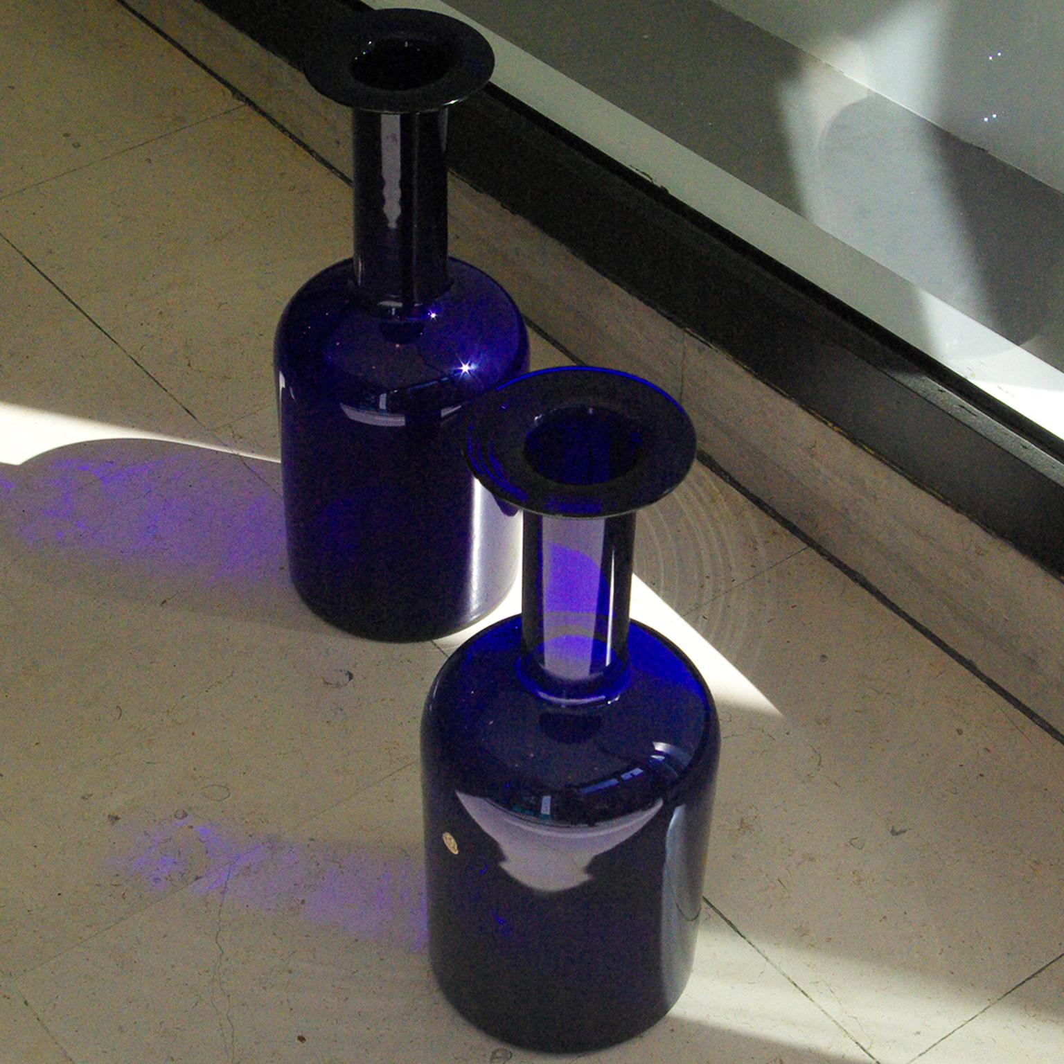 Two big vases by Otto Brauer for Holmegaard from the sixties in translucent blue (one of the three original colors). In pristine condition and one vase still wears the original brand sticker. Measures: 44 cm.

 