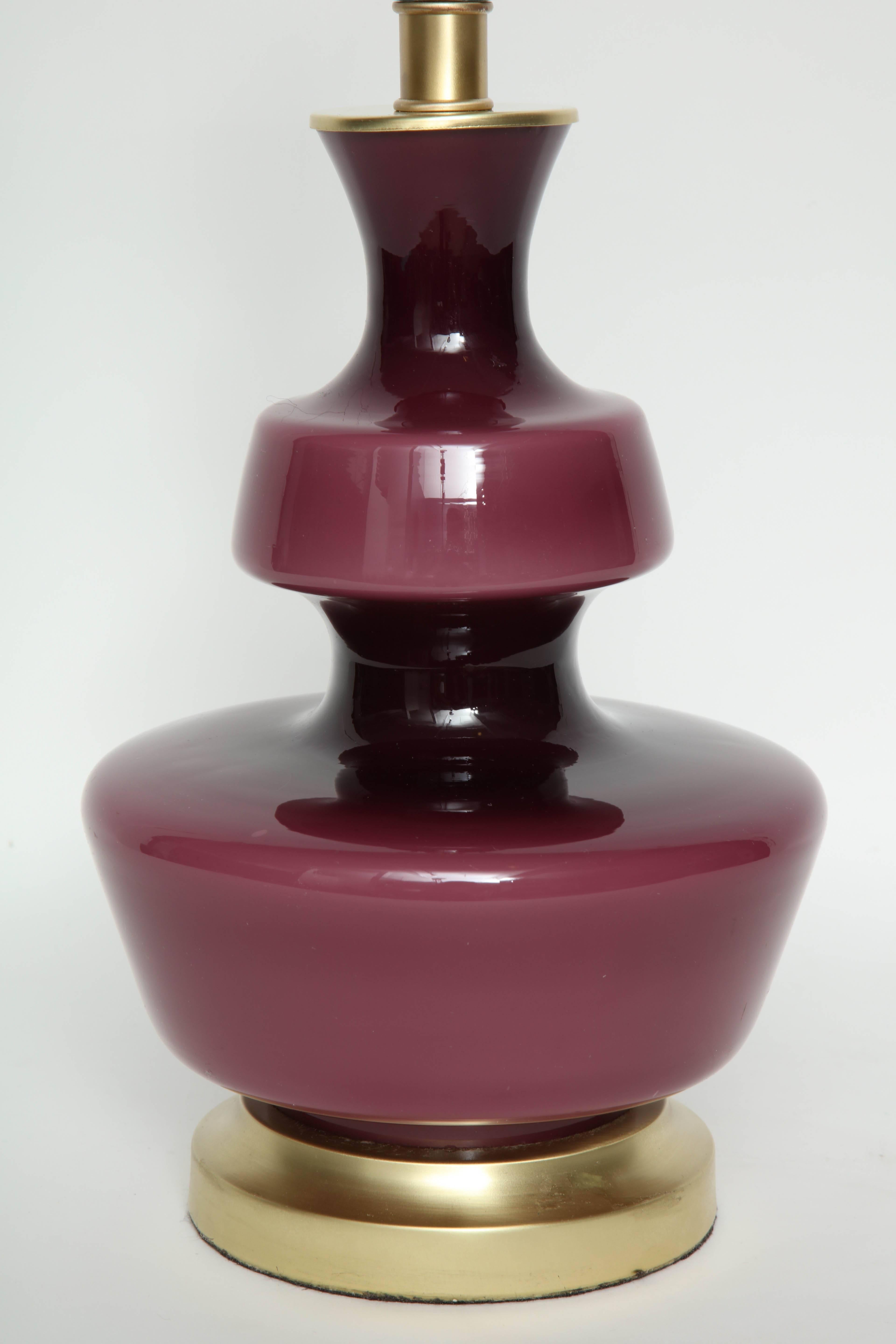 Pair of Scandinavian Modern pawn shaped raspberry colored glass lamps on satin brass bases by Holmegaard of Sweden. Rewired for use in the USA.

Glass portion measures 12.25