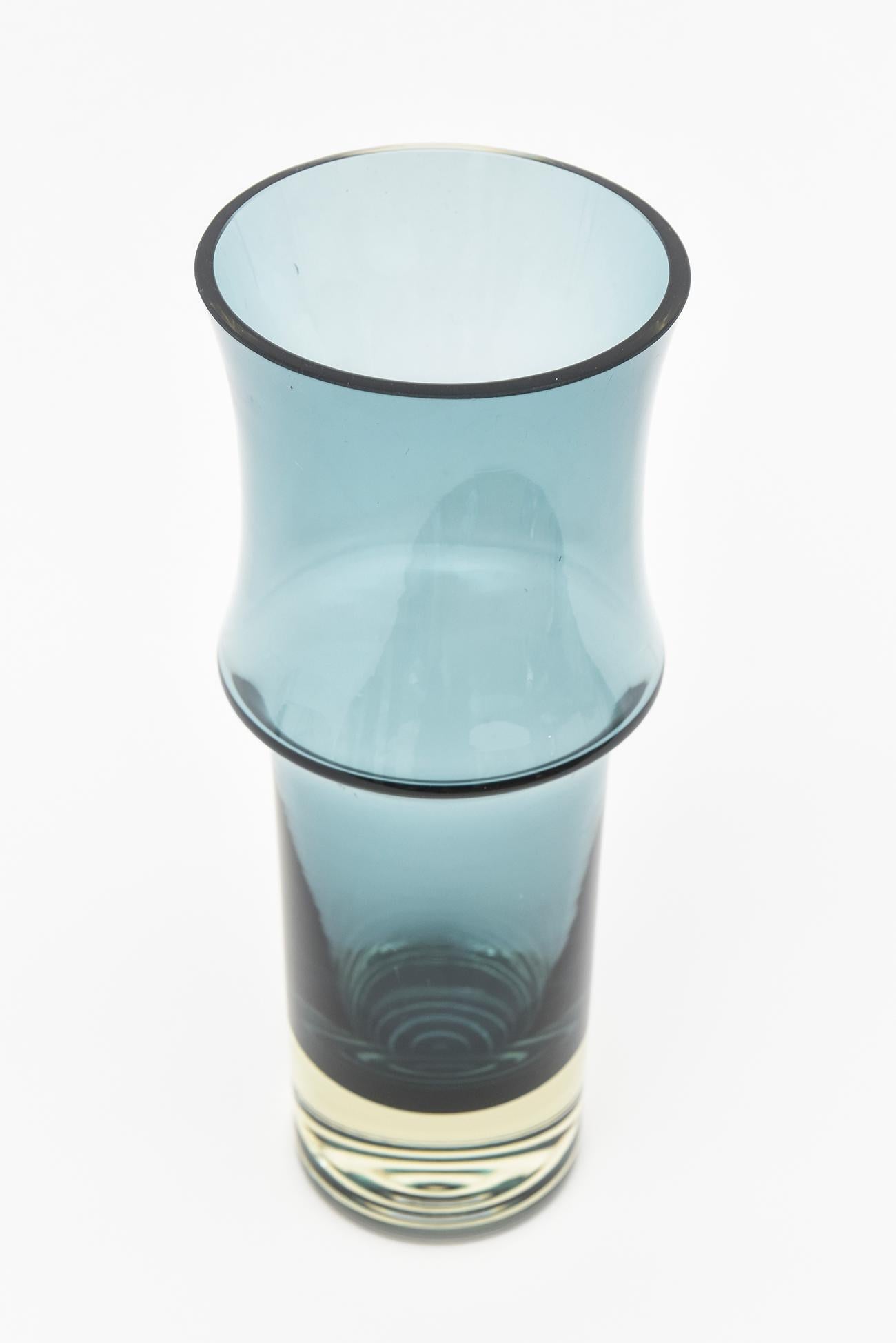 The shape and color of this beautiful simple vintage vase by Holmegaard is a great example of Danish mid century modern. The form is lovely and reinforced with the stunning but hard to describe color that rings teal blue cornflower with a light hint