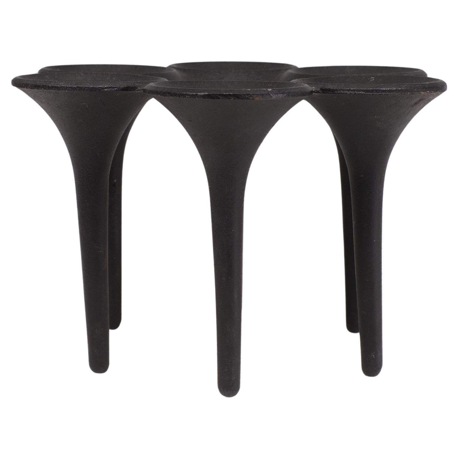 HOLMGREN ILLUMS BOLIGHUS. A  cast iron candle holder. The way they make the cast iron, gives them a structure on the surface. It looks very basic, natural and strong. They are really heavy.  The  are marked with made in Denmark.
There are Six  holes