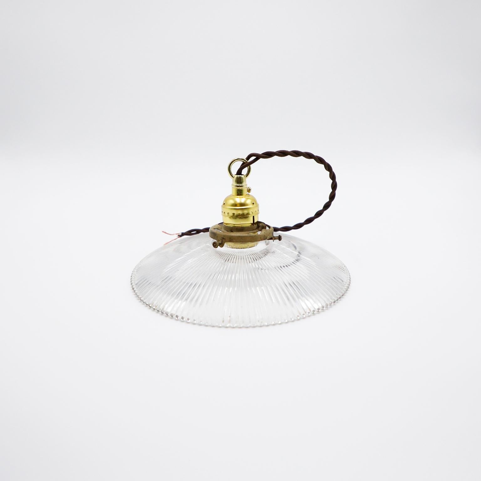 We offer this Holophane Clear Glass Vintage Industrial Pendant Light. Prismatic glass shades in excellent condition. The electrical system is new and works perfectly.