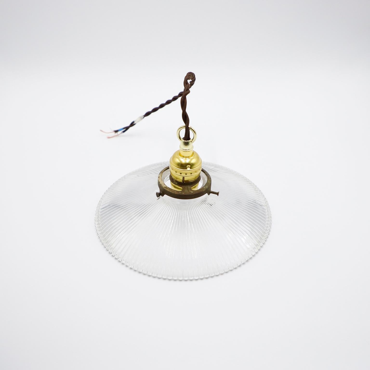 We offer this Holophane Clear Glass Vintage Industrial Pendant Light. Prismatic glass shades in excellent condition. The electrical system is new and works perfectly.
