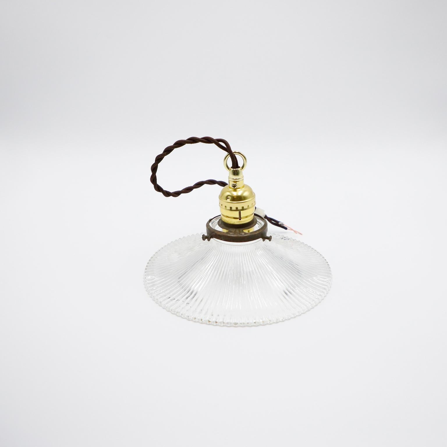 We offer this Holophane Clear Glass Vintage Industrial Pendant Light. Prismatic glass shades in excellent condition. The electrical system is new and works perfectly.