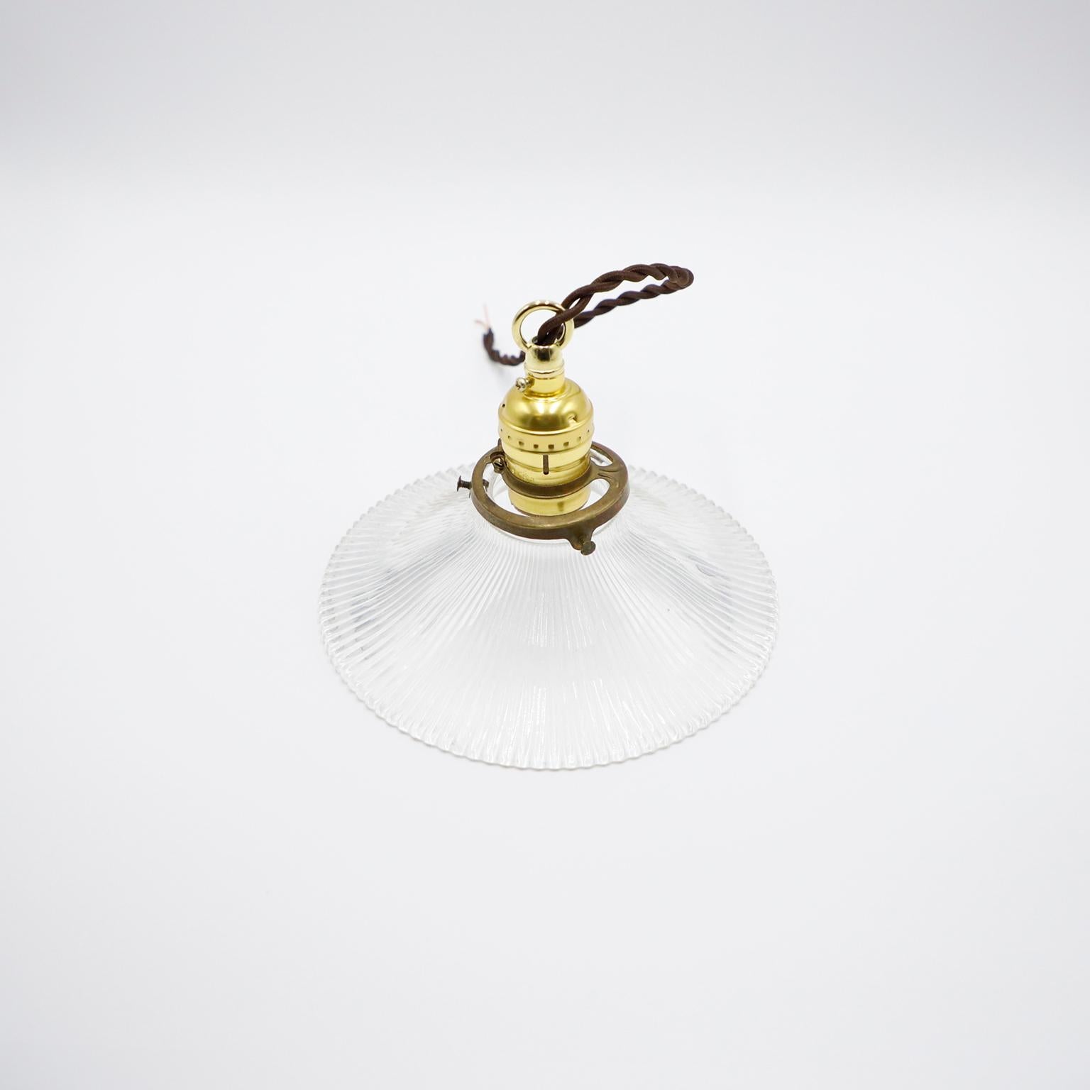 We offer this Holophane Clear Glass Vintage Industrial Pendant Light. Prismatic glass shades in excellent condition. The electrical system is new and works perfectly.