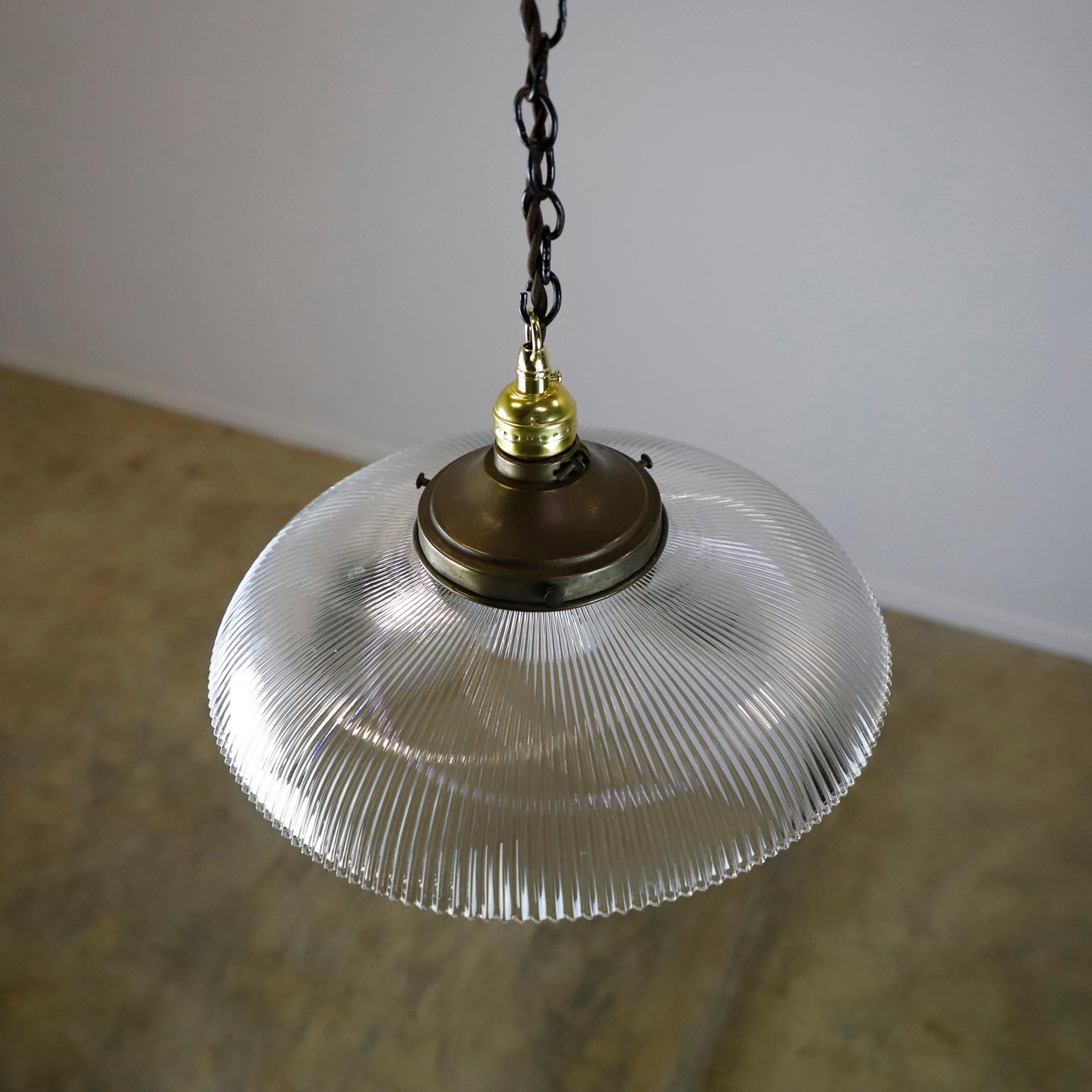 We offer this Holophane Clear Glass Vintage Industrial Pendant Light. Prismatic glass shades in excellent condition. The electrical system is new and works perfectly.