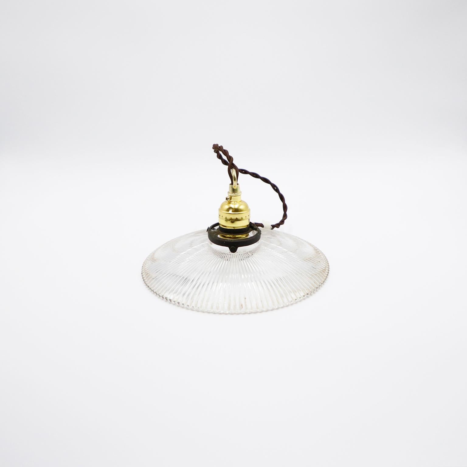 We offer this Holophane Clear Glass Vintage Industrial Pendant Light. Prismatic glass shades in excellent condition. The electrical system is new and works perfectly.