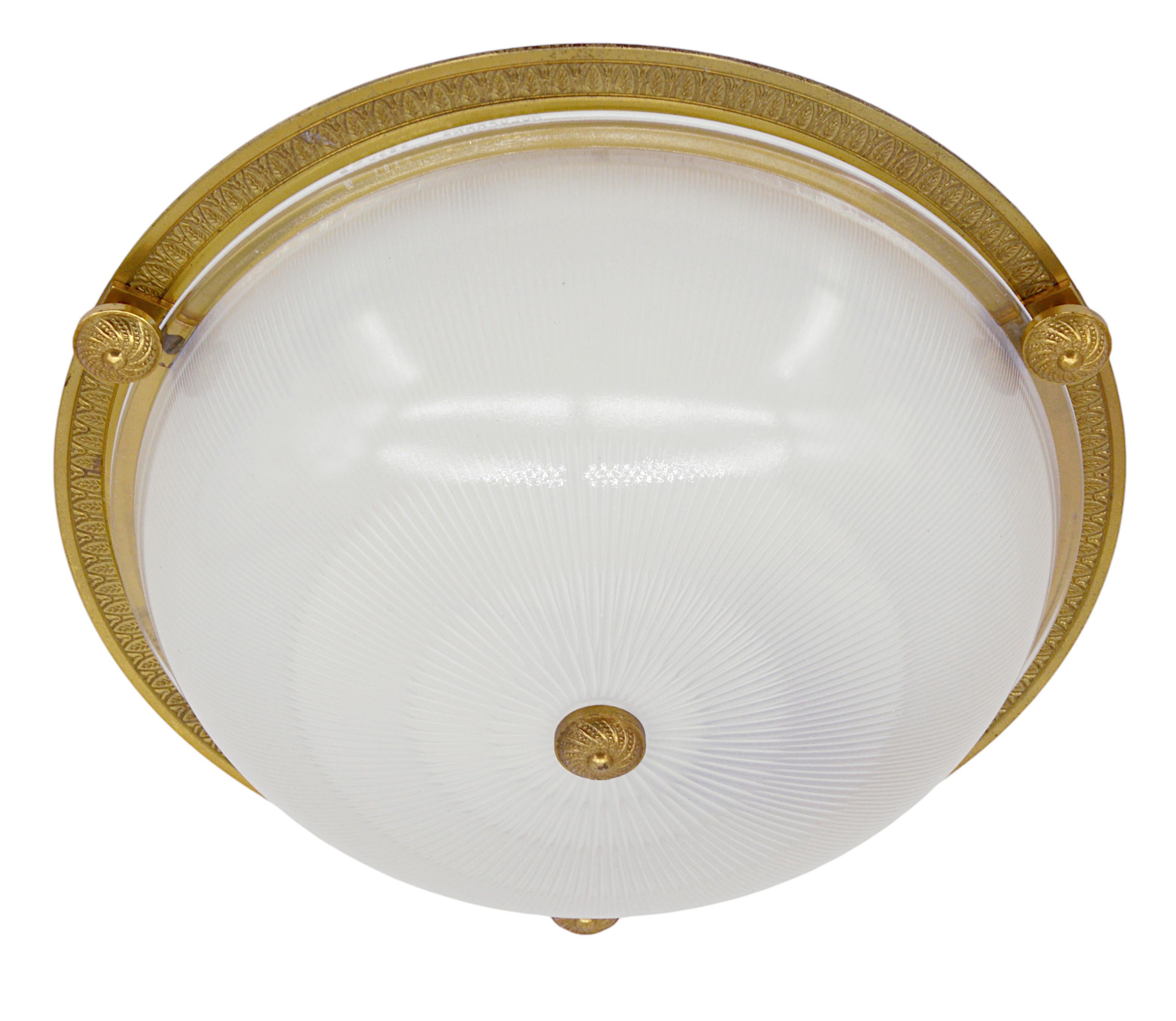 French Art Deco flush mount by Holophane (Les Andelys), France, 1930s. Ribbed molded glass and bronze. Height : 4