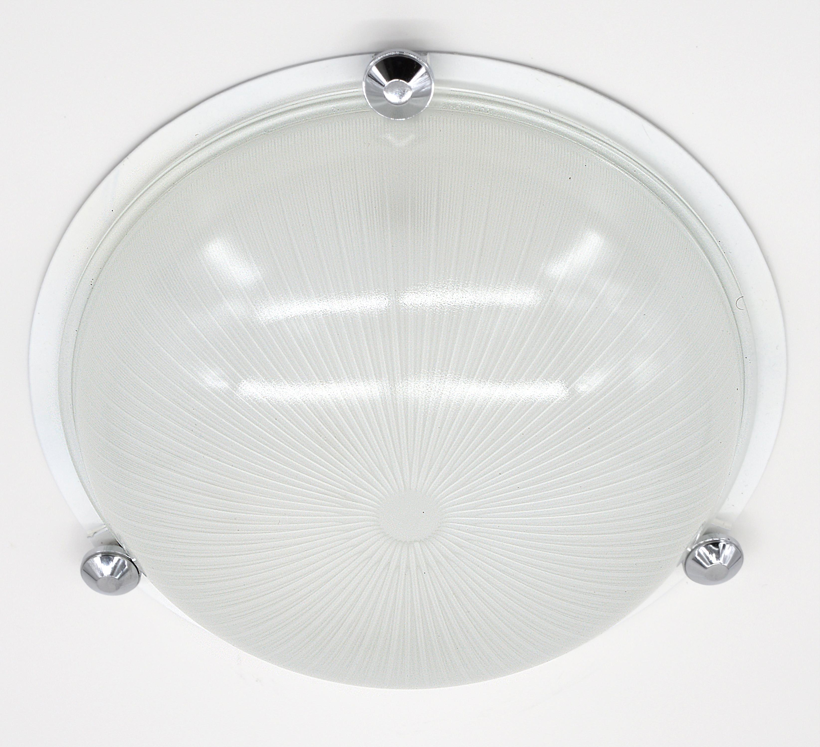 French modernist Art Deco flush mount, France, 1930s. The pair is no longer available. Milk glass shade. Metal plaque.  Chromed buttons. Height: 3.9
