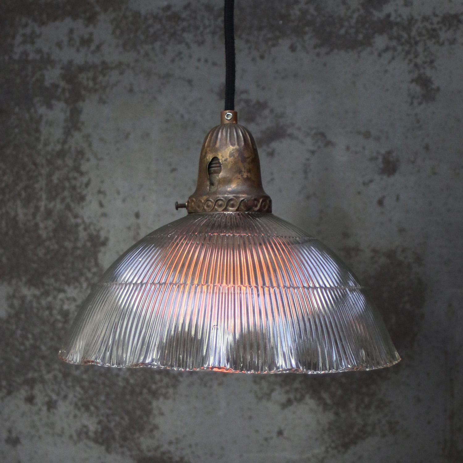 French Holophane glass pendant lights
Brass top with glass shade.

Weight: 0.50 kg / 1.1 lb

Priced per individual item. All lamps have been made suitable by international standards for incandescent light bulbs, energy-efficient and LED bulbs.