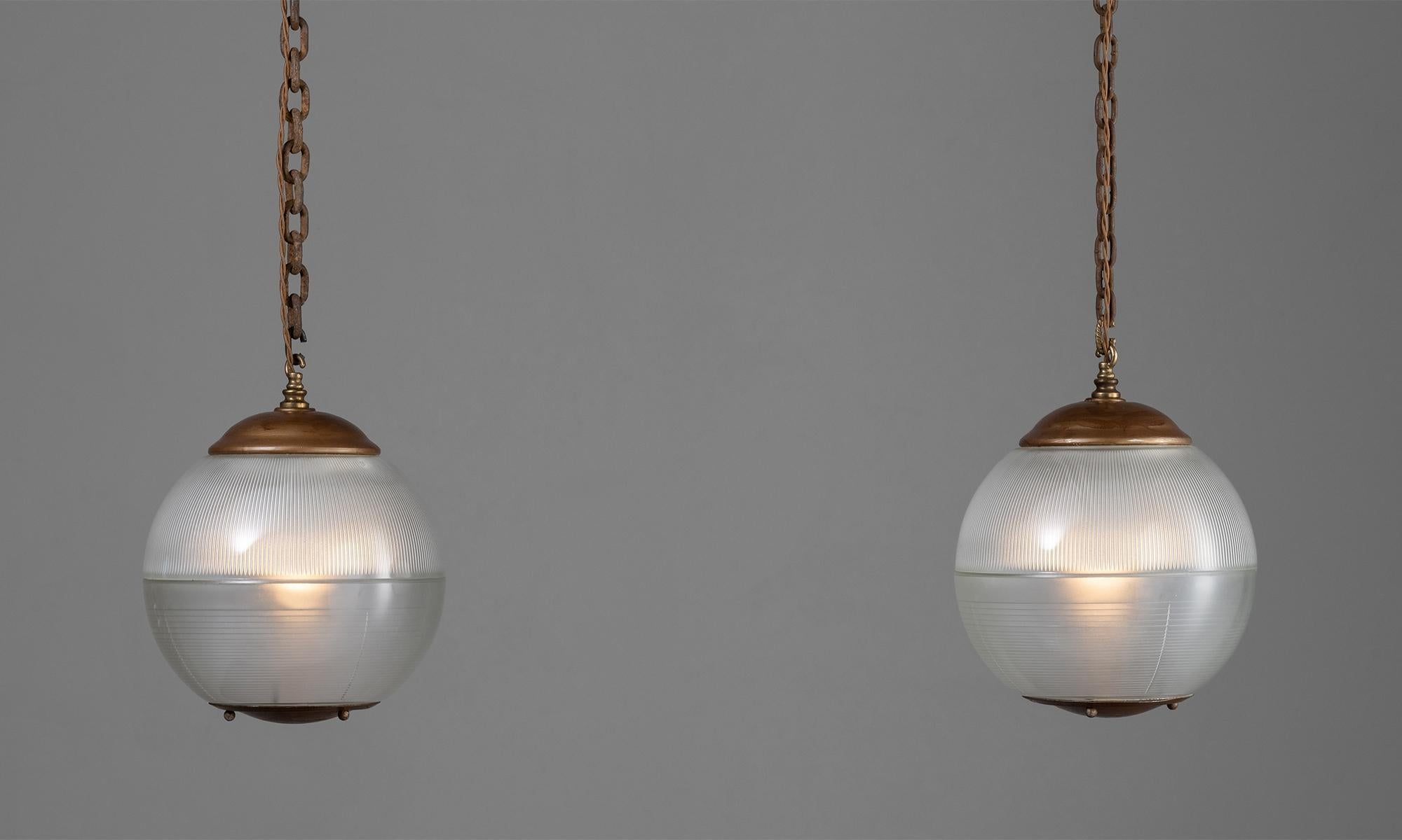 *Please note the price is per unit, and the lights are sold individually*

Holophane globe pendant

Italy, Circa 1950.

Holophane glass pendants with brass details.

Measures: 9.5”diameter x 12”height.