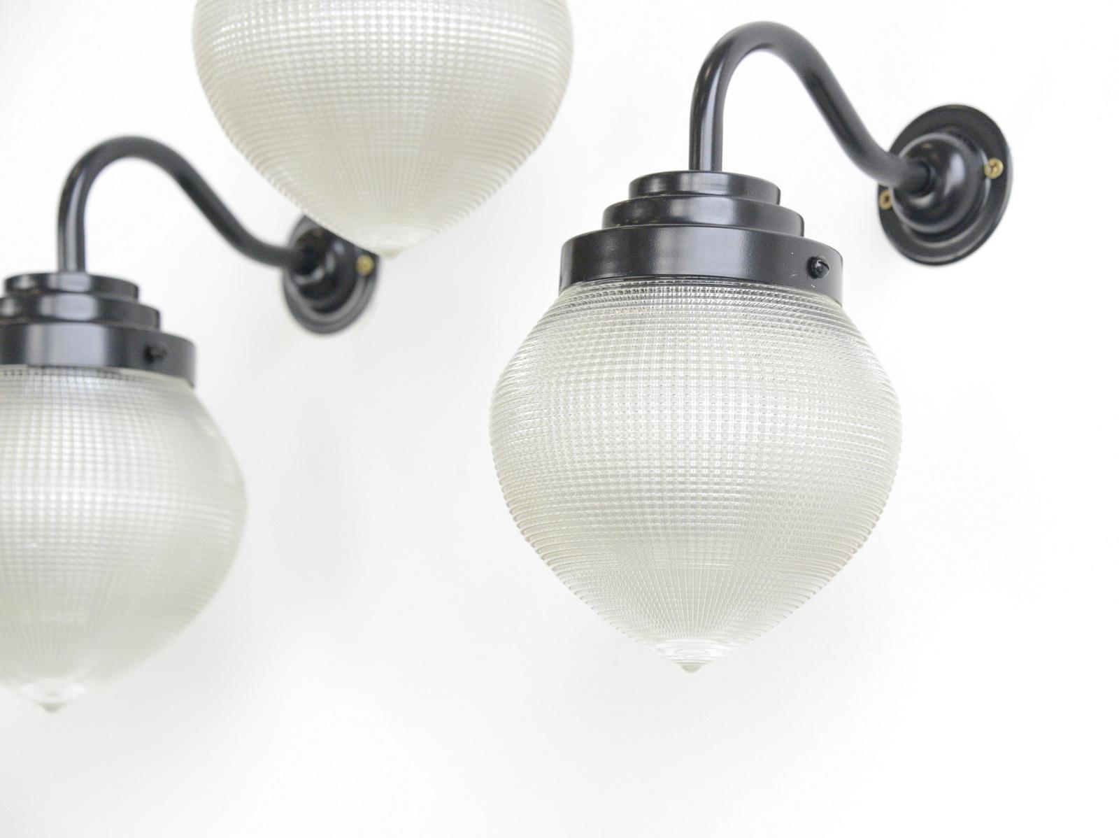 Holophane globe wall lights, circa 1920s

- Price is per light
- Teardrop prismatic glass shades
- Curved satin black steel arm
- Takes E27 fitting bulbs
- Marked Holophane, USA
- American, 1920s
- Measures: 16cm wide x 25cm deep x 22cm