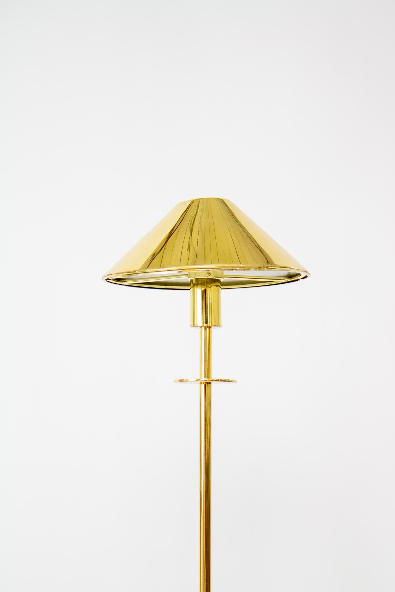 German Halogen Brass Floor Lamp from Holtkoetter Leuchten. Crafted with precision, the lamp features a handy dimming technology – a simple turn adjusts the lighting. In a polished brass with a sleek compact shade, it effortlessly adds modern